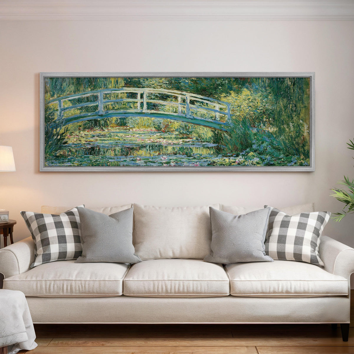 Japanese bridge over a water lily pond panoramic canvas print above a white sofa in a bright living room