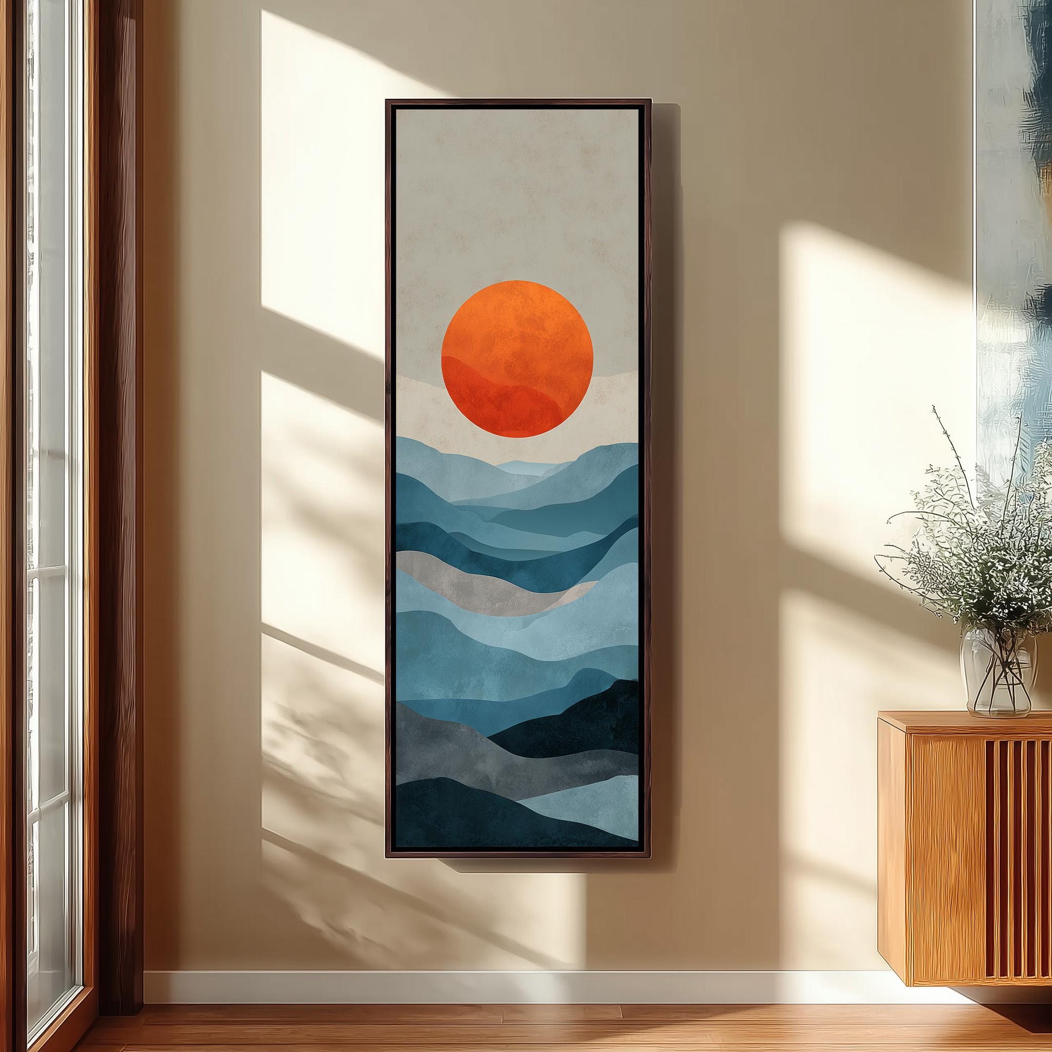 a large abstract painting hanging on a wall, depicting a landscape with mountains and a sun in the sky.