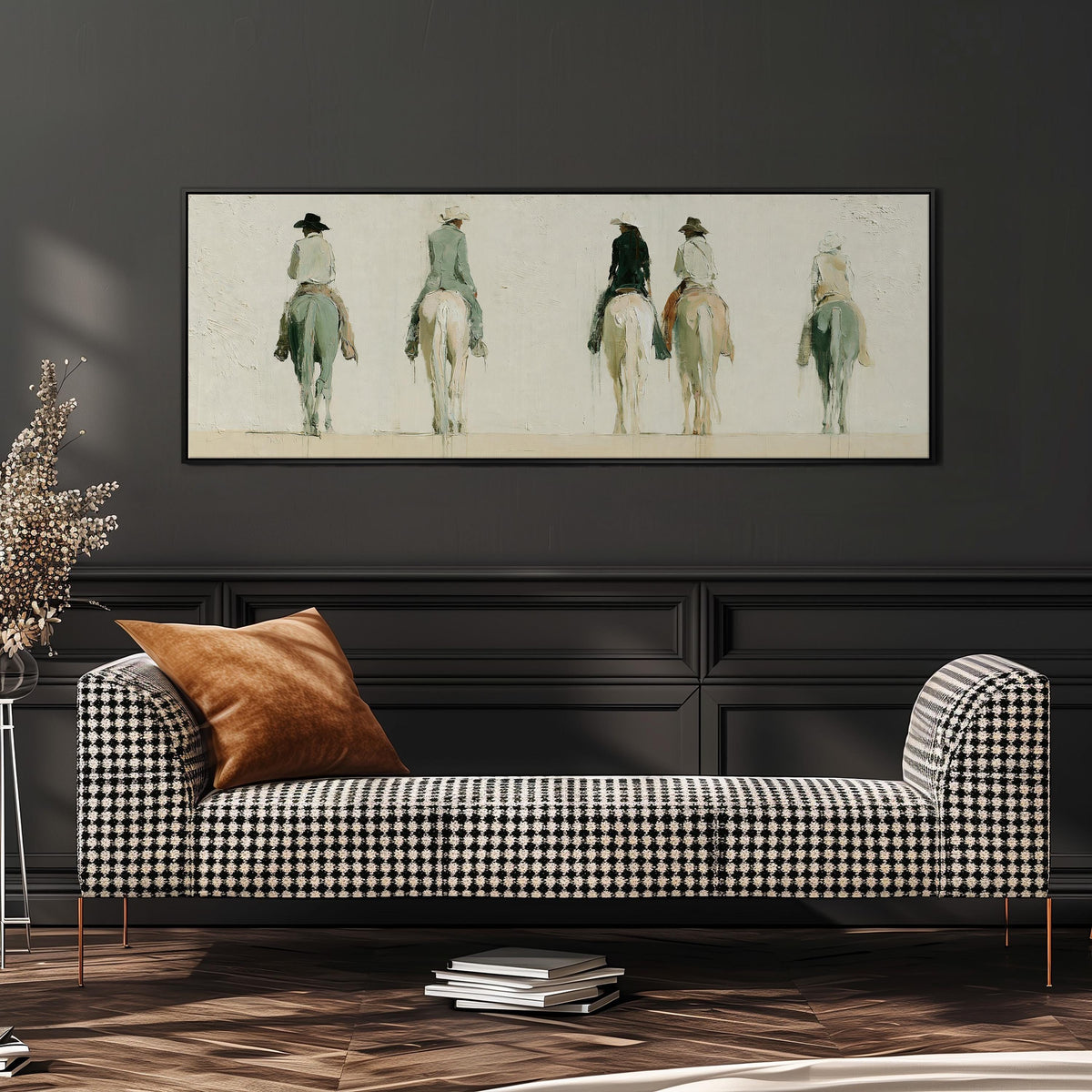 Riders on horseback seen from behind wide panoramic canvas print above a bench in a dark living room