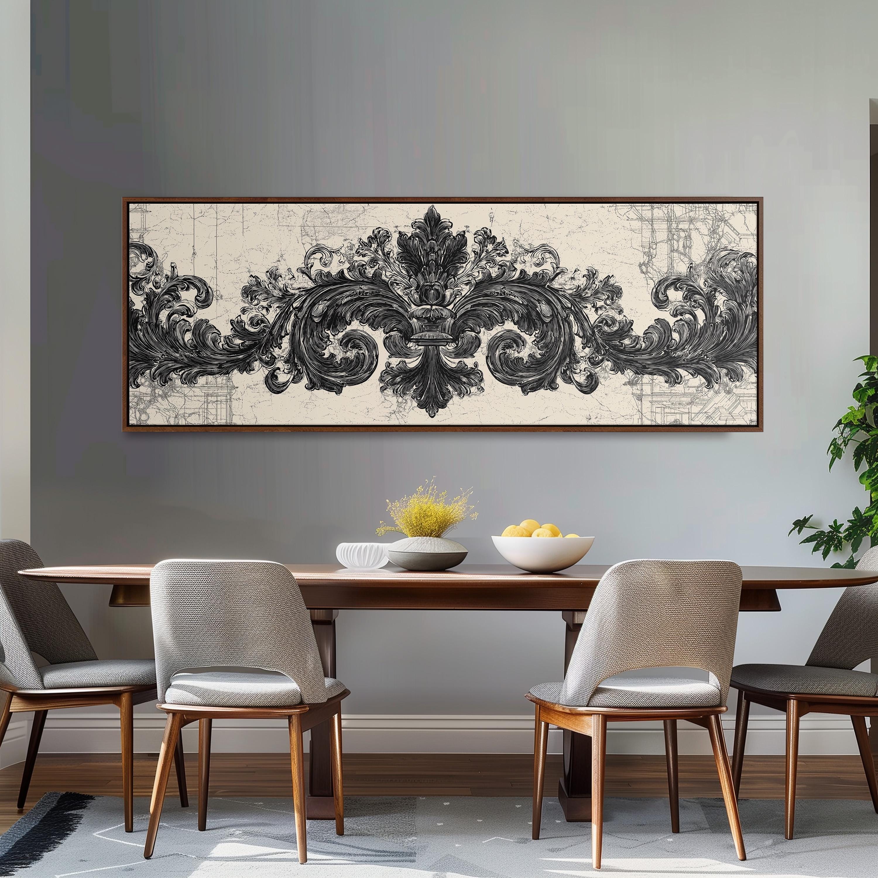 a dining room with a large, ornate black and white artwork hanging on the wall above a wooden dining table with four chairs. The table is set with a bowl of fruit and a vase of flowers, creating a cozy and inviting atmosphere.