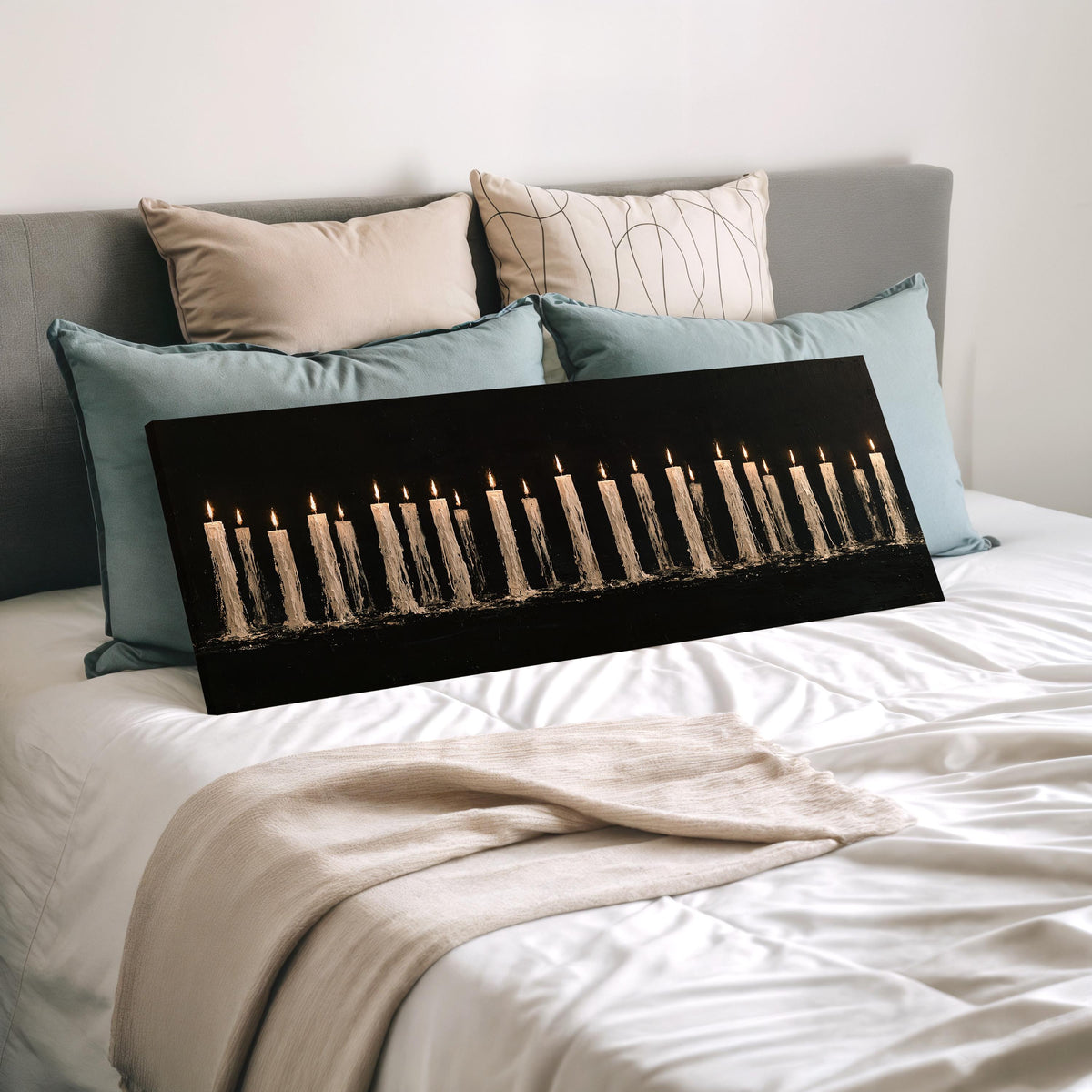 Long row of flickering candles wide panoramic canvas print laid on a bed to show its size
