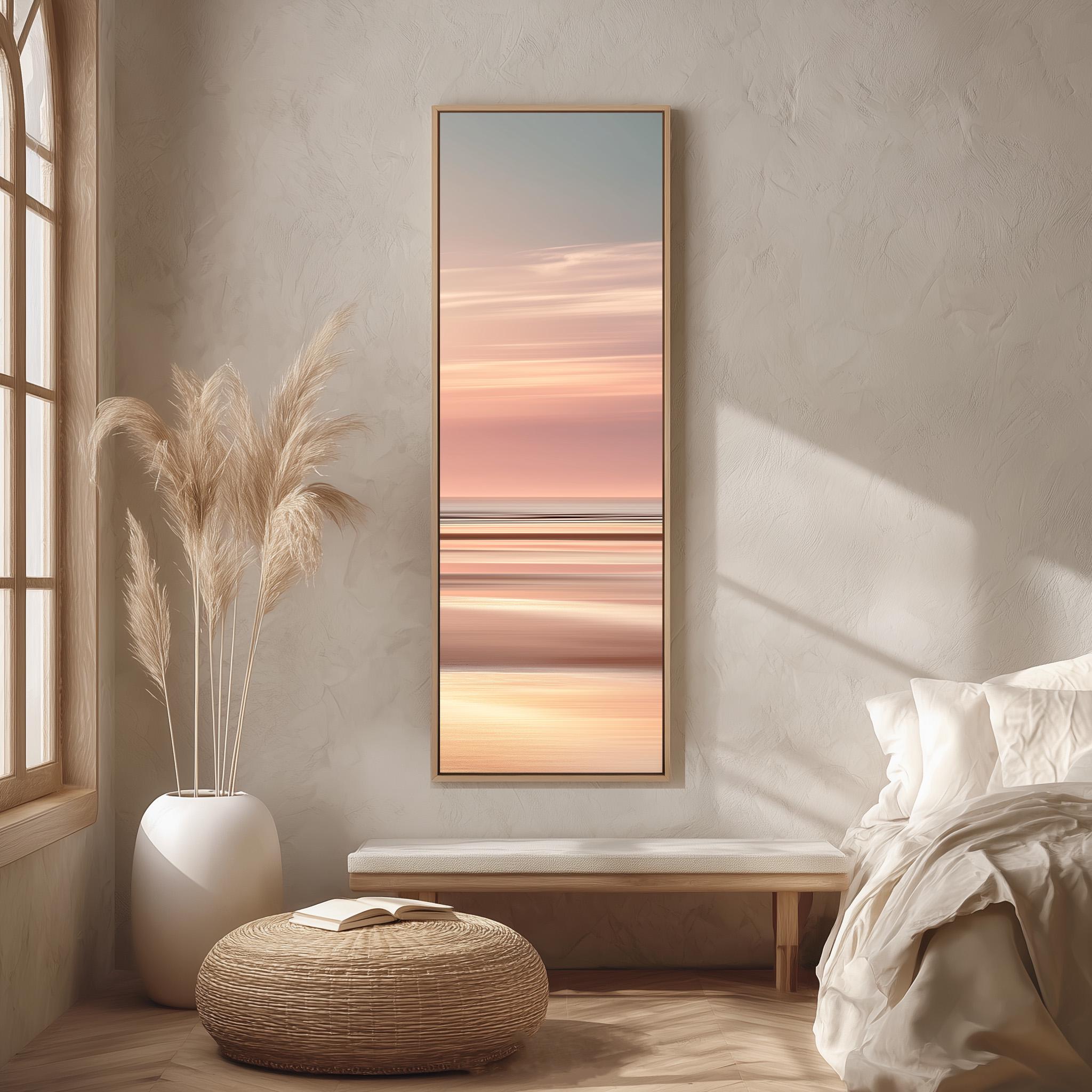 a serene bedroom scene with a large window, a bed with white bedding, a wicker ottoman, and a framed landscape painting hanging on the wall.