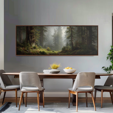 a dining room with a large painting of a forest scene hanging on the wall above a wooden table with four chairs. The painting depicts a misty forest with tall trees and a path winding through the undergrowth. The table is set with a bowl of fruit and a vase of flowers, creating a cozy and inviting atmosphere.