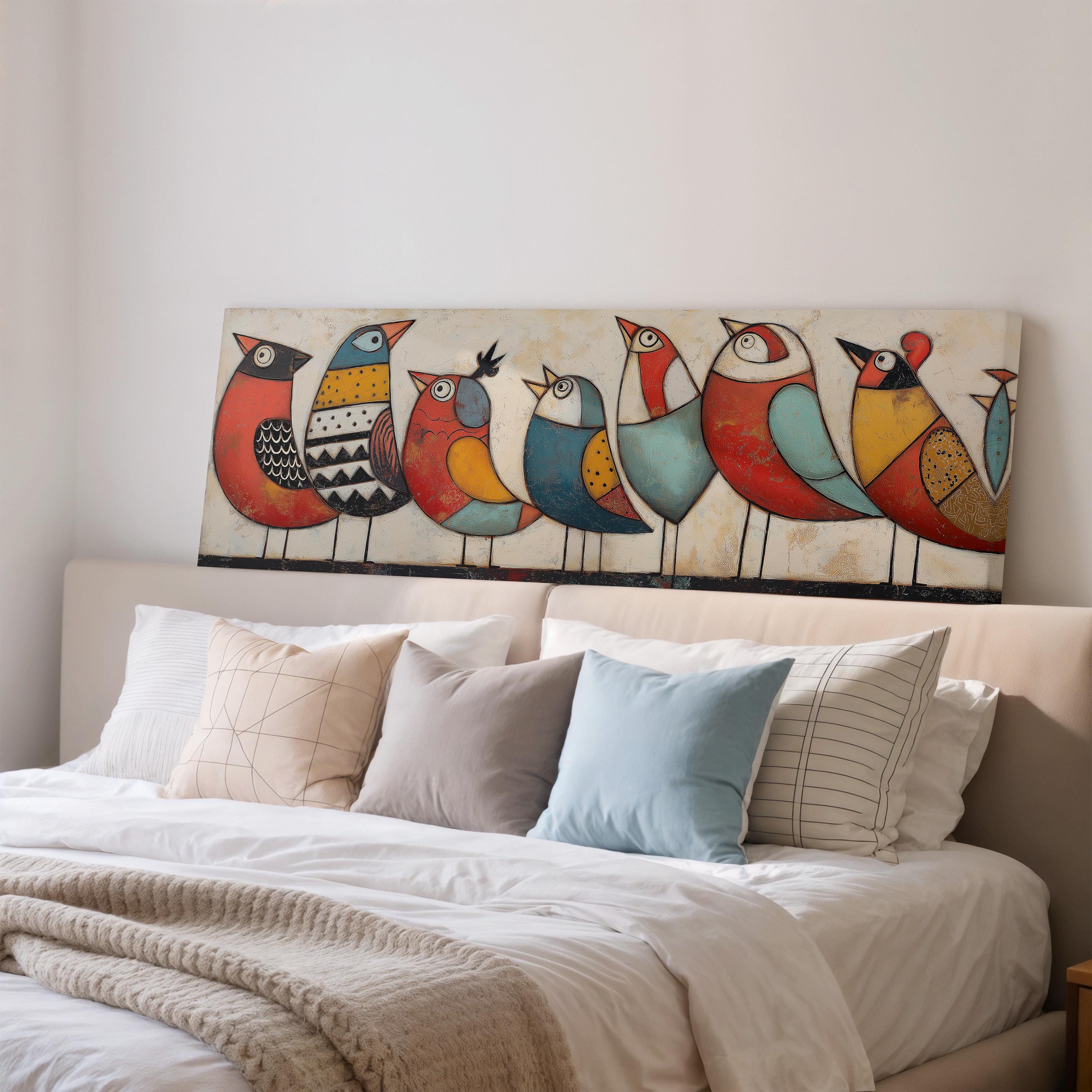 a bedroom with a large painting of colorful birds on the wall above a bed with white pillows and a gray blanket.