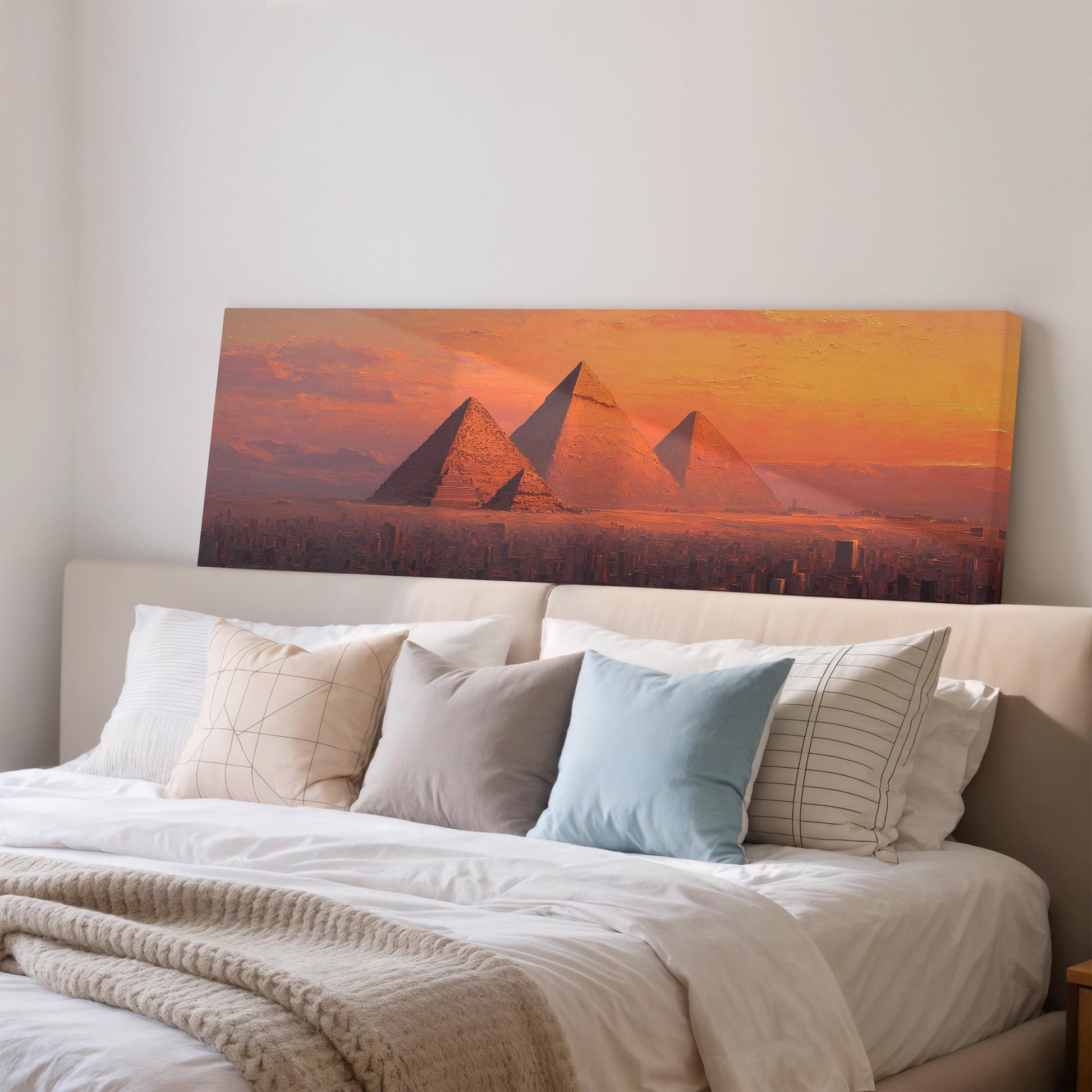 a large painting of the pyramids of Giza in Egypt, with a warm sunset in the background.