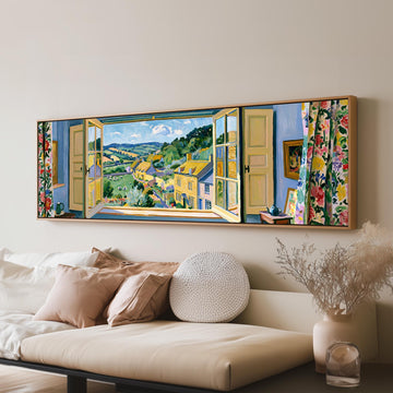 English countryside village through a window long horizontal canvas print above a sofa in a living room
