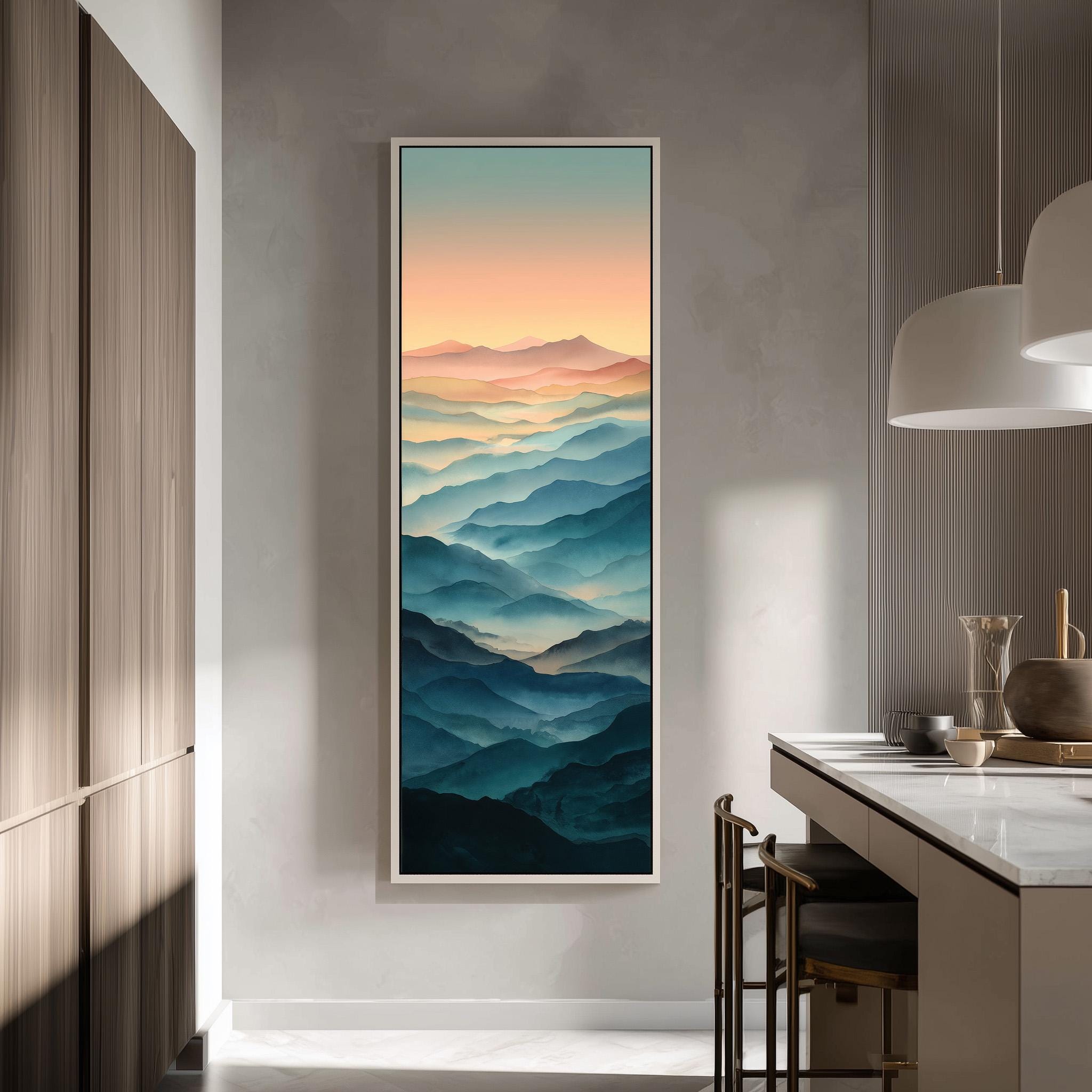 a large framed painting of mountains with a warm, colorful sunset in the background, hanging on a wall in a modern kitchen.