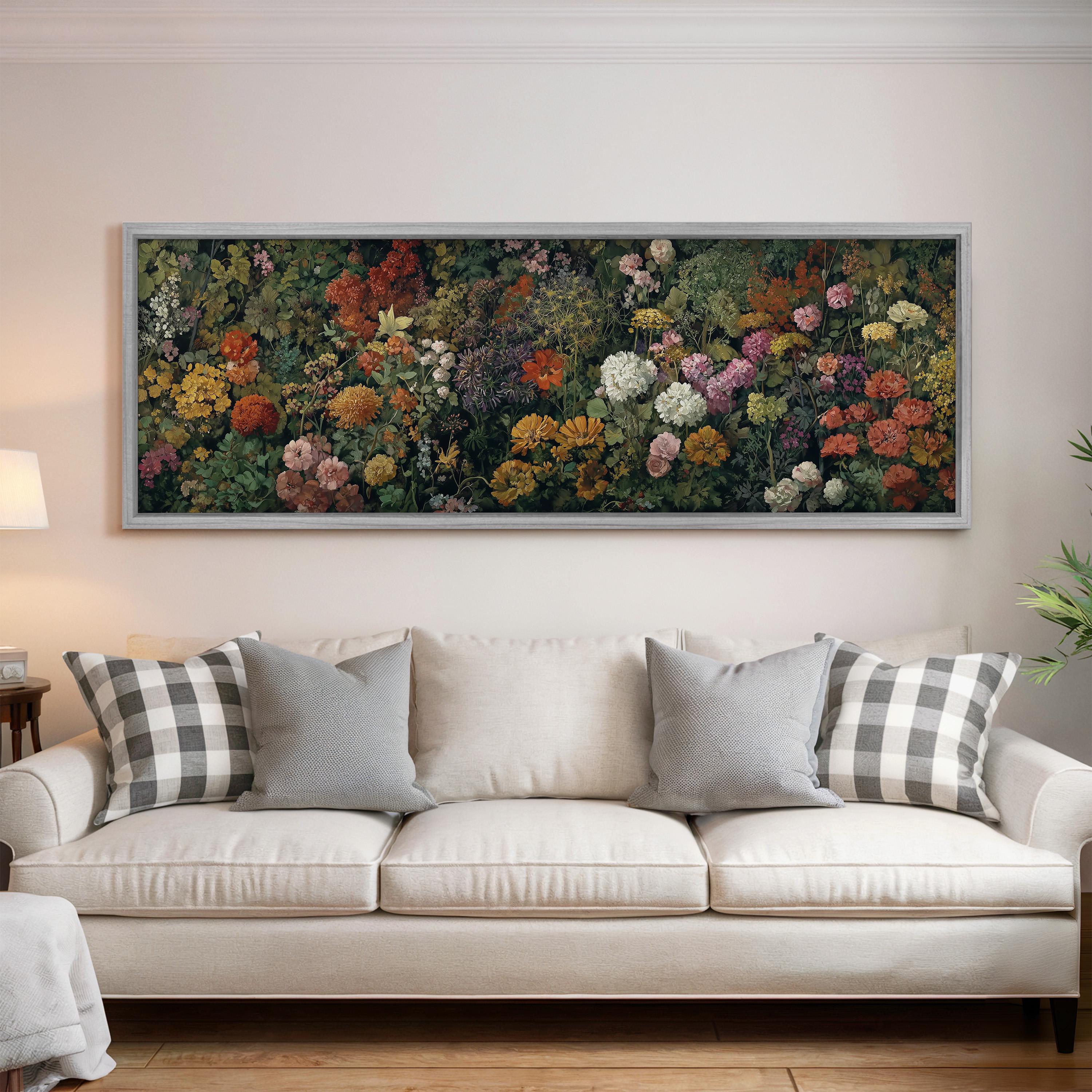 a large, framed painting of a colorful garden scene hanging on a wall above a white sofa with gray and white plaid throw pillows.