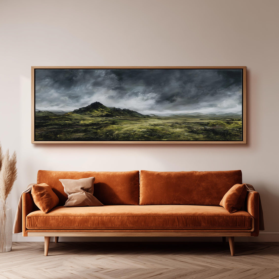 a dining room with a large painting of a landscape hanging on the wall above a wooden dining table with four chairs. The painting depicts a cloudy, mountainous landscape with a sense of tranquility and natural beauty.