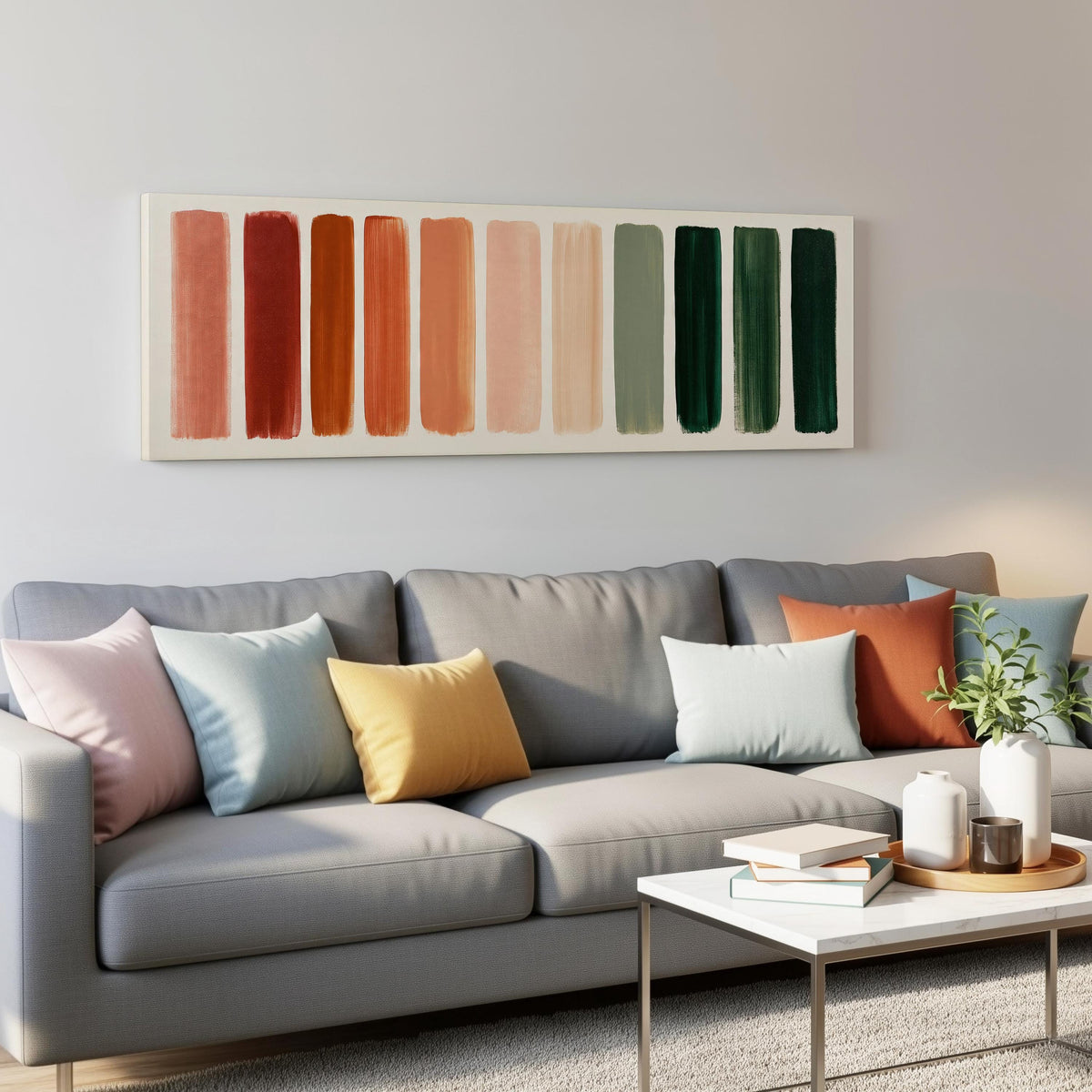 Brushed swatches from terracotta to forest green panoramic canvas print above a grey sofa in a living room