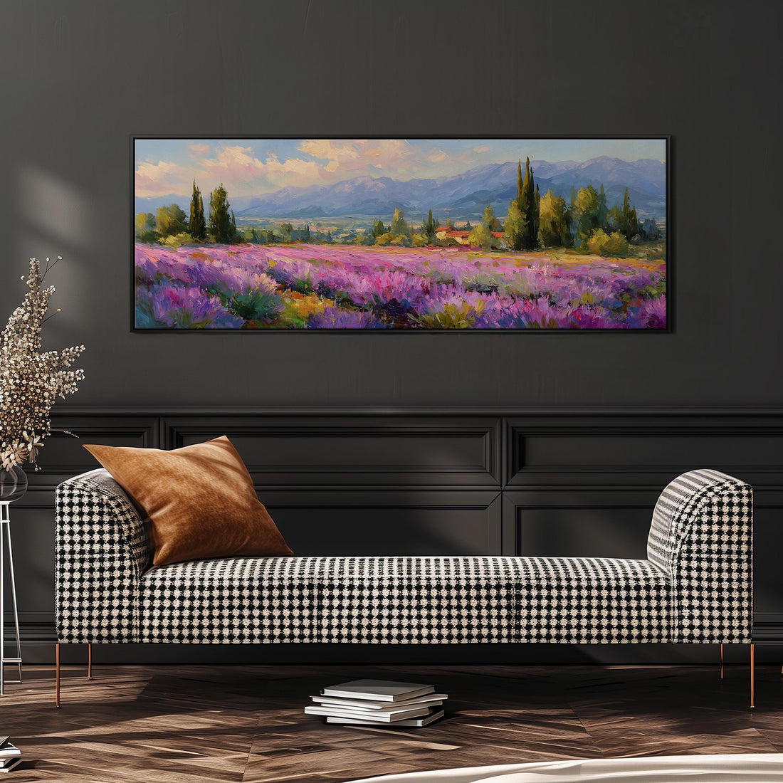 a large, framed painting of a field of purple flowers hanging on a wall above a brown sofa.