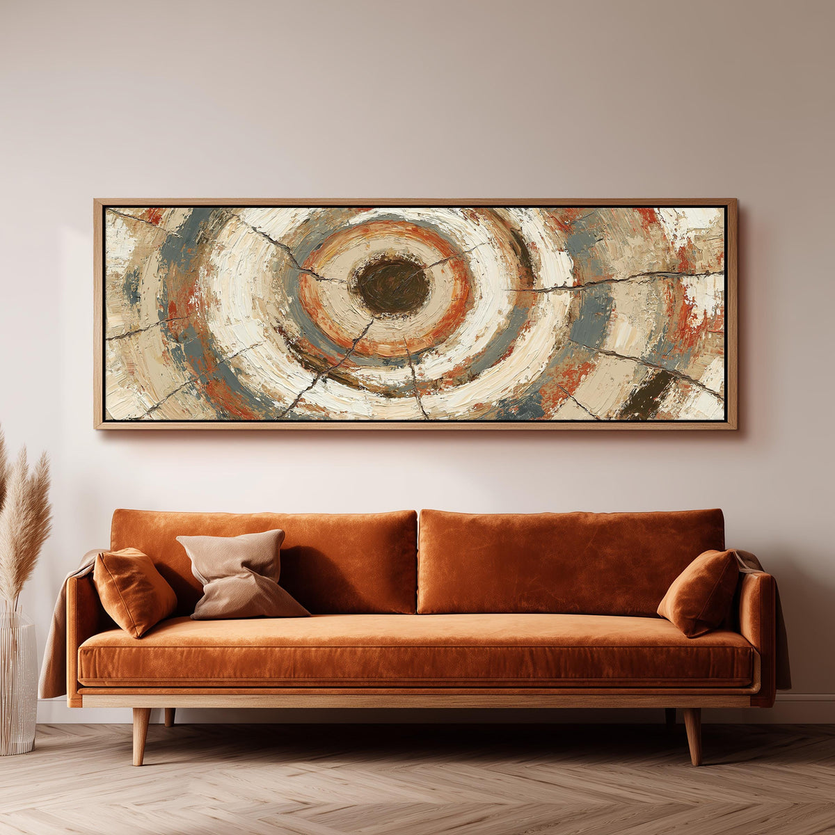 Rust and navy textured tree ring panoramic canvas print above a sofa in a living room