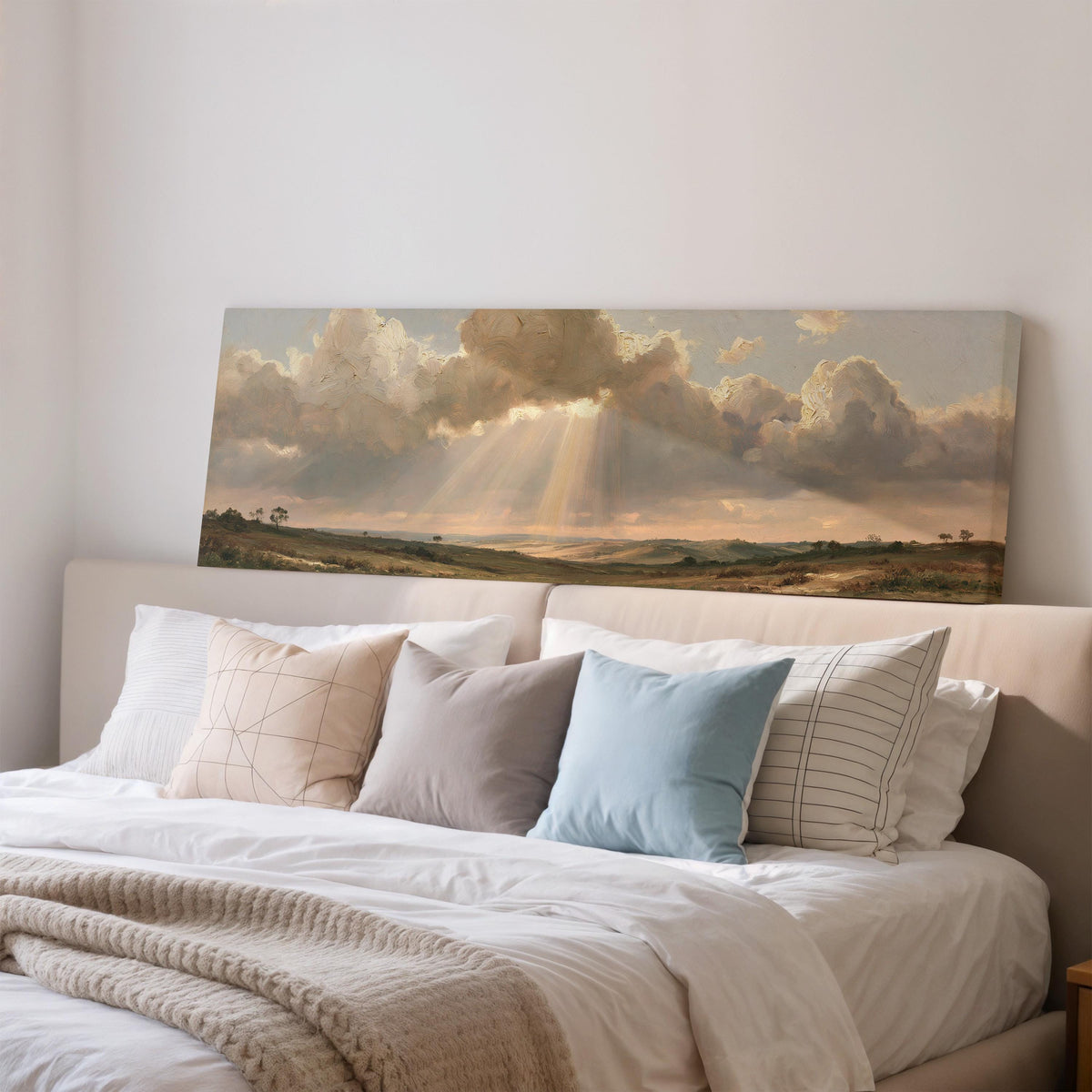 Sunbeams breaking through clouds over plains wide panoramic canvas print above a bed in a bedroom