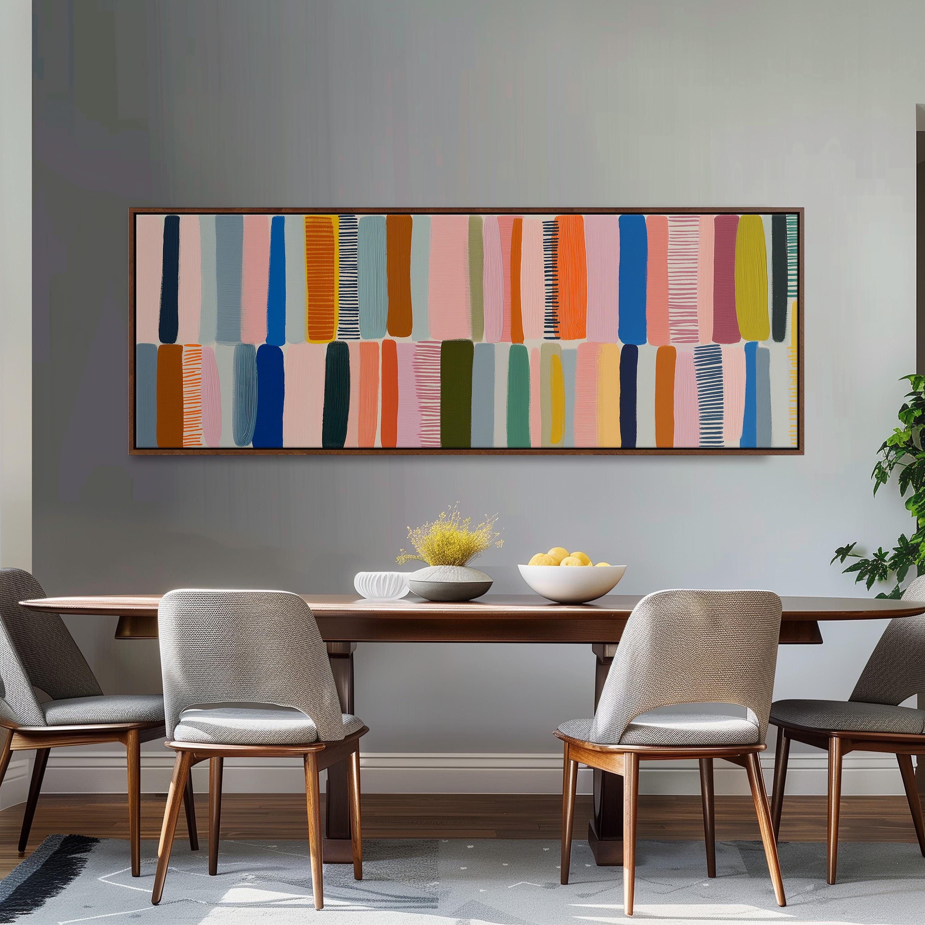 a modern dining room with a wooden table and four chairs. Above the table, there is a large abstract painting with vertical lines in various colors, including pink, blue, green, and orange. The painting is framed and hangs on the wall above the dining area.