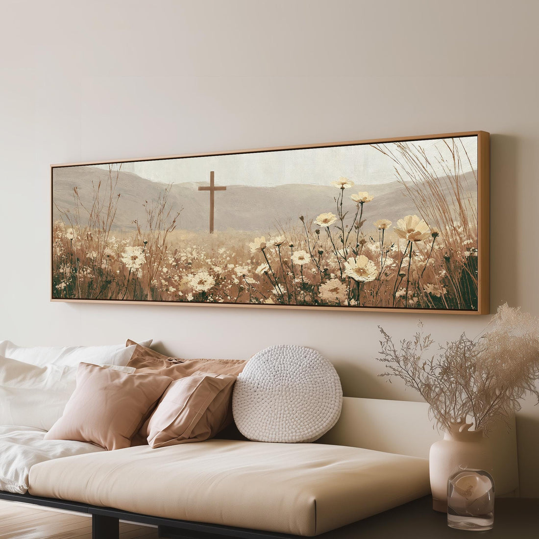 Wooden cross in a cream wildflower field long horizontal canvas print above a sofa in a living room