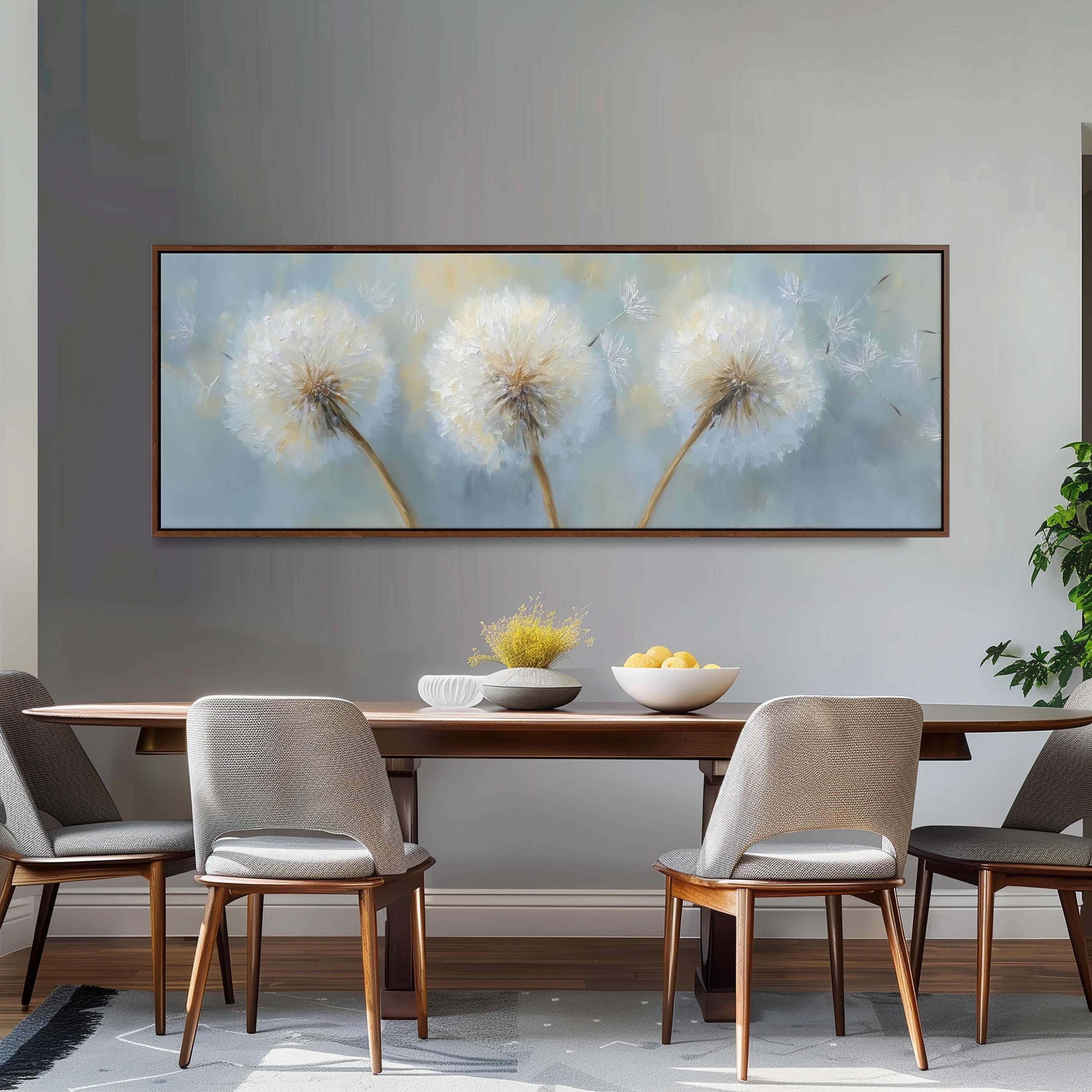a dining room with a large painting of dandelions hanging on the wall above a wooden dining table with four chairs. The table is set with a bowl of fruit and a vase of flowers, creating a cozy and inviting atmosphere.