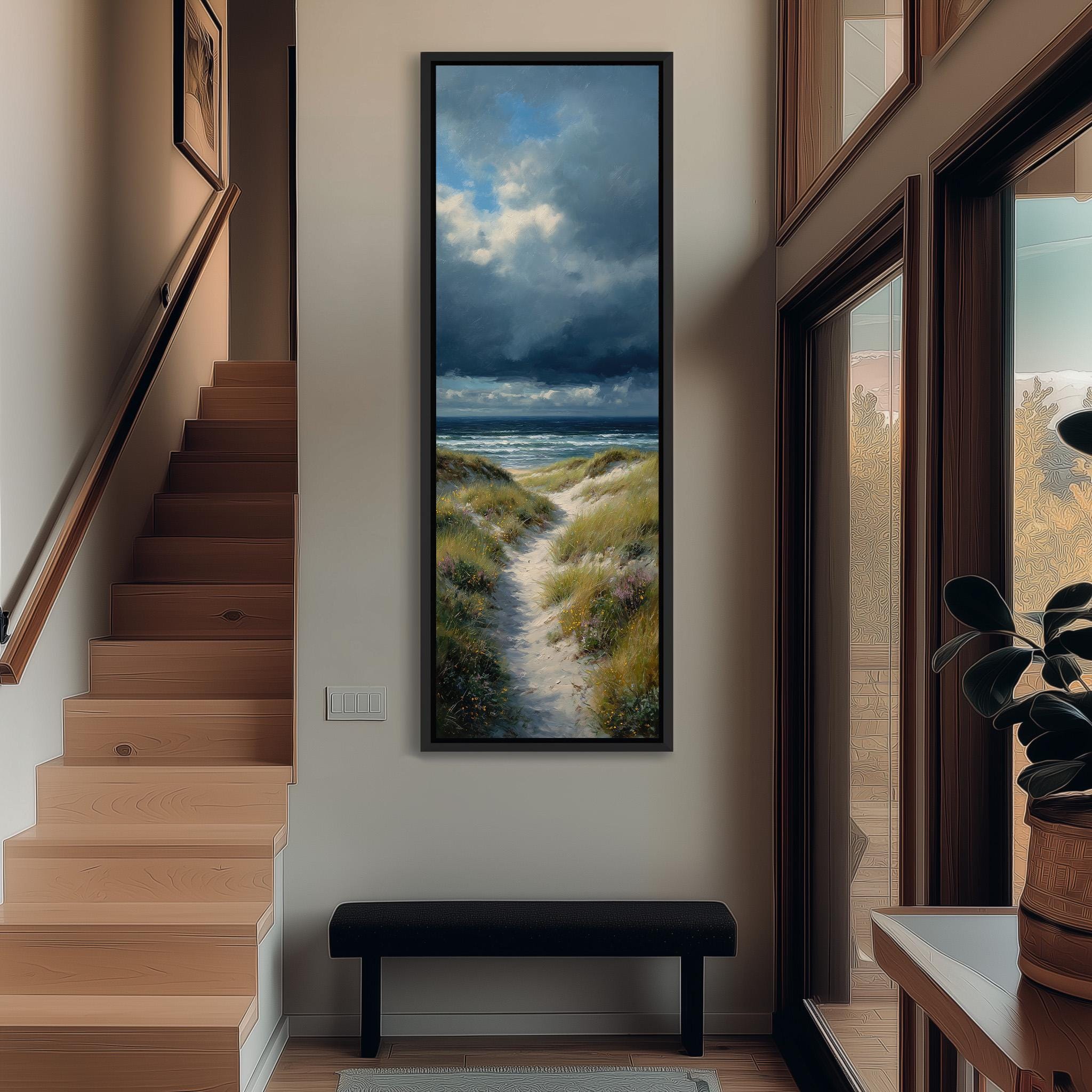 a hallway with a large painting of a beach scene hanging on the wall. The painting depicts a path leading to the beach, with a cloudy sky above. The hallway has wooden stairs leading up to the painting, and a bench is placed in front of the painting.