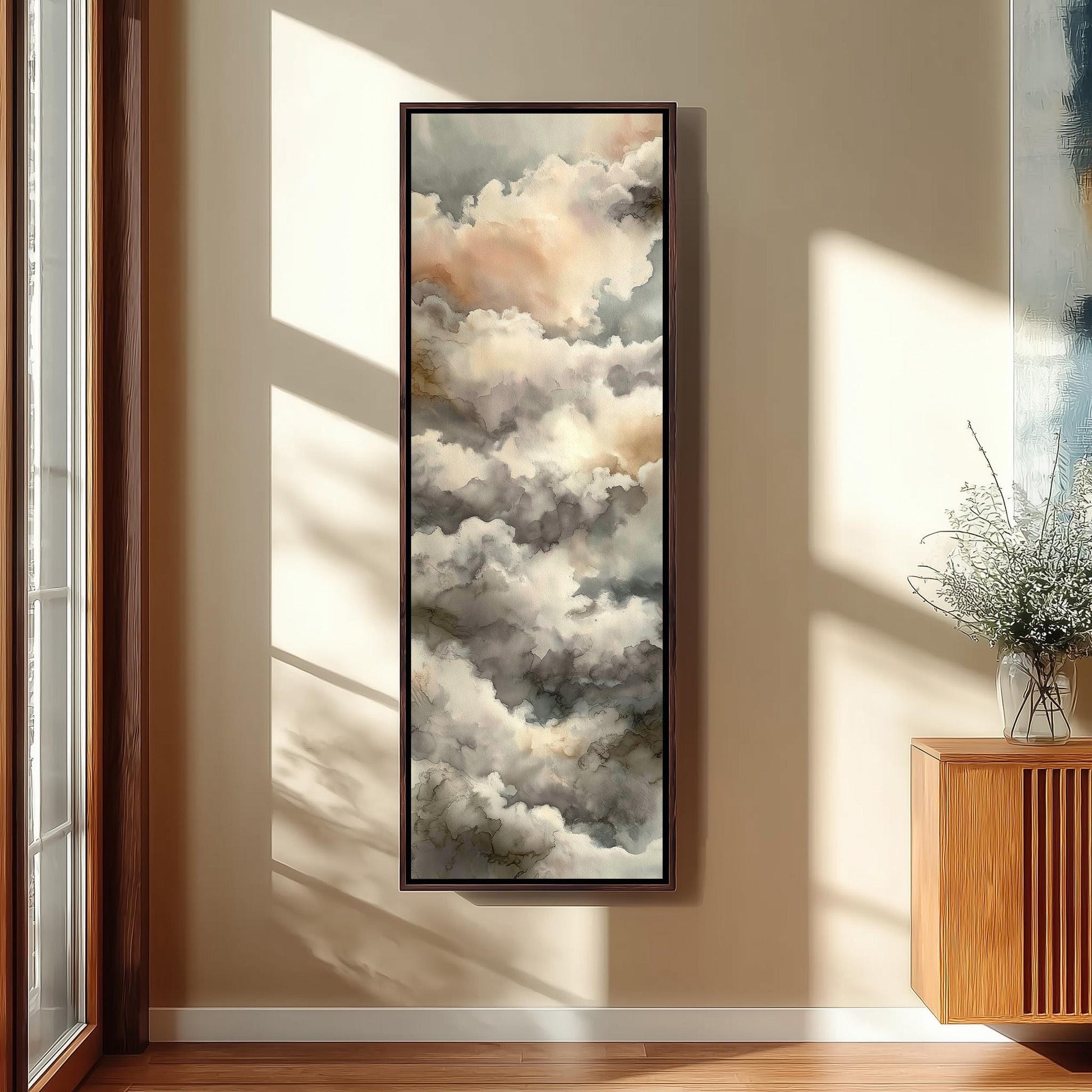 a large framed painting of clouds hanging on a wall in a room with wooden furniture.