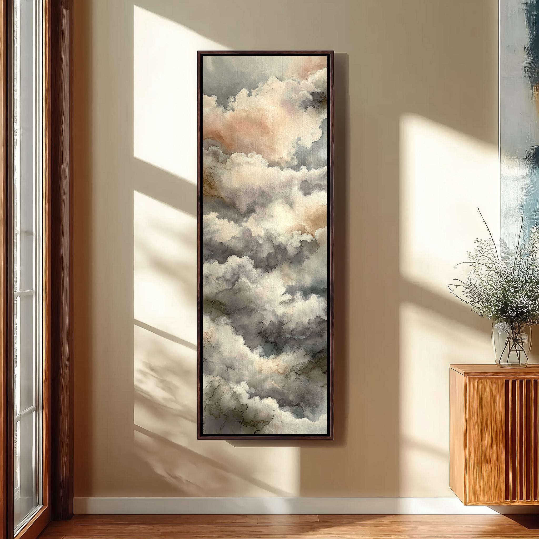 a large framed painting of clouds hanging on a wall in a room with wooden furniture.