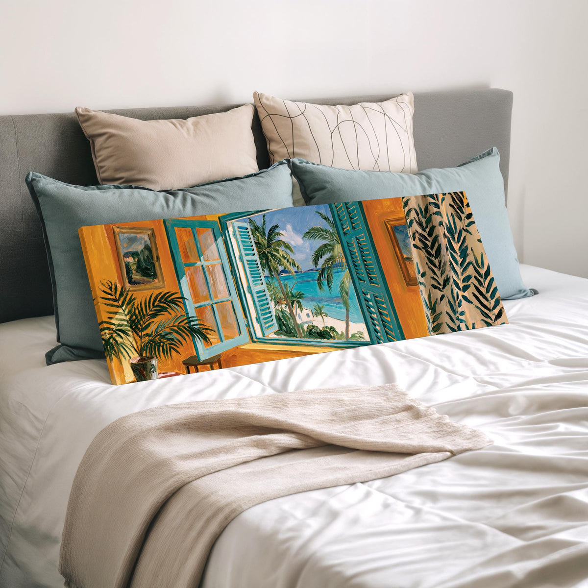 Beach house window overlooking palms and sea wide panoramic canvas print laid on a bed to show its size