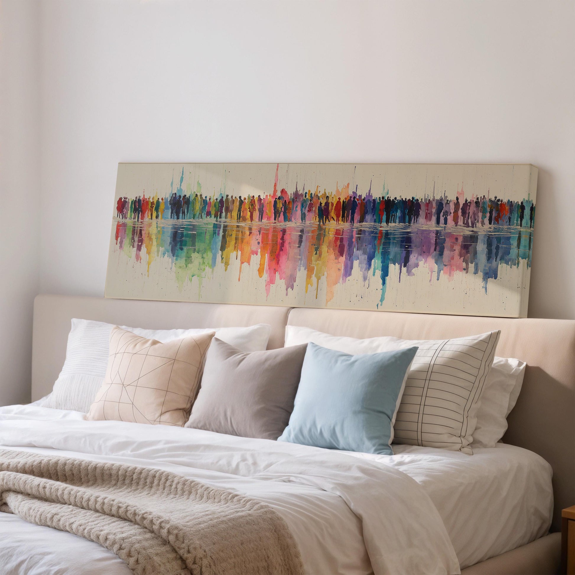 a large, colorful abstract painting hanging on a wall above a bed with white bedding and pillows.