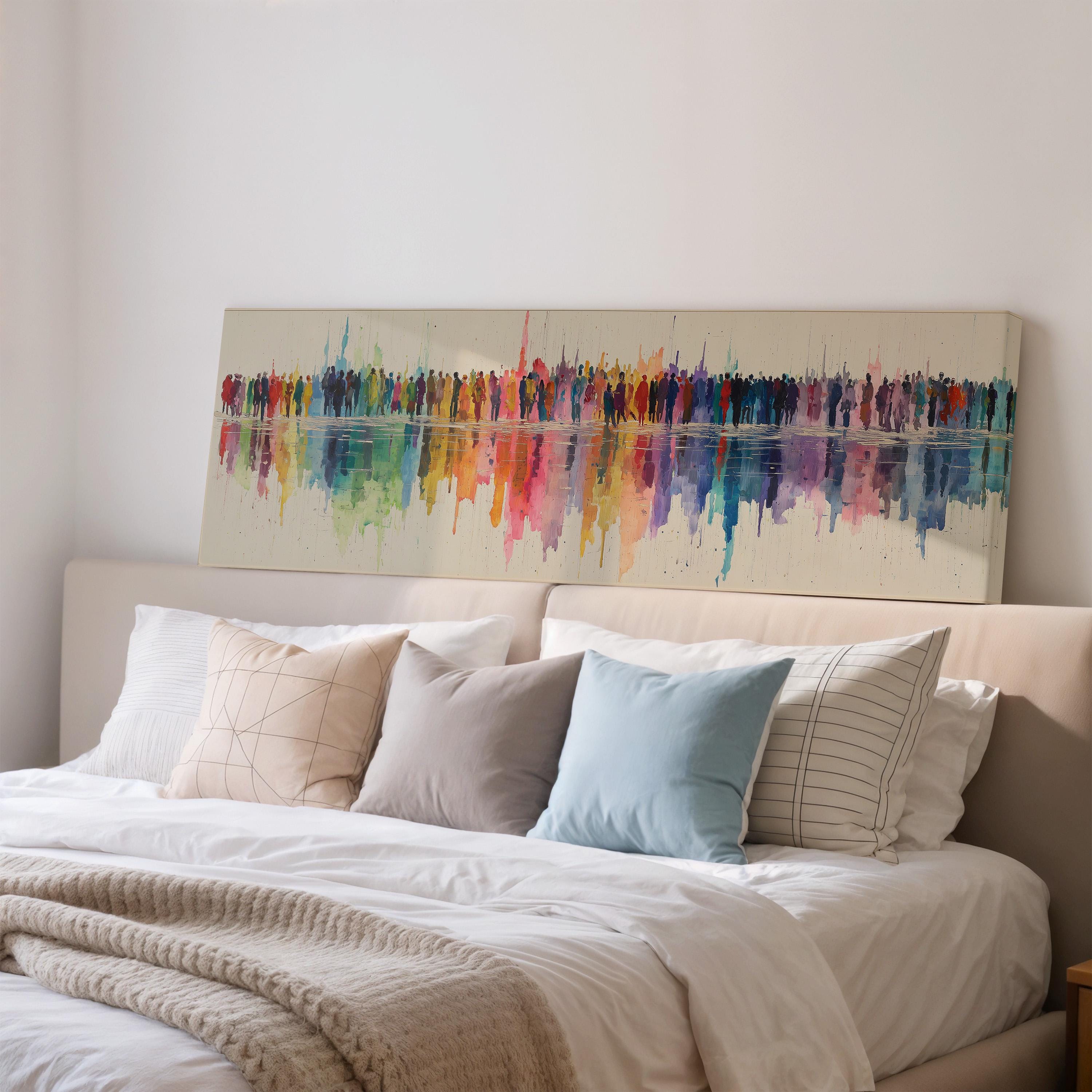 a large, colorful abstract painting hanging on a wall above a bed with white bedding and pillows.