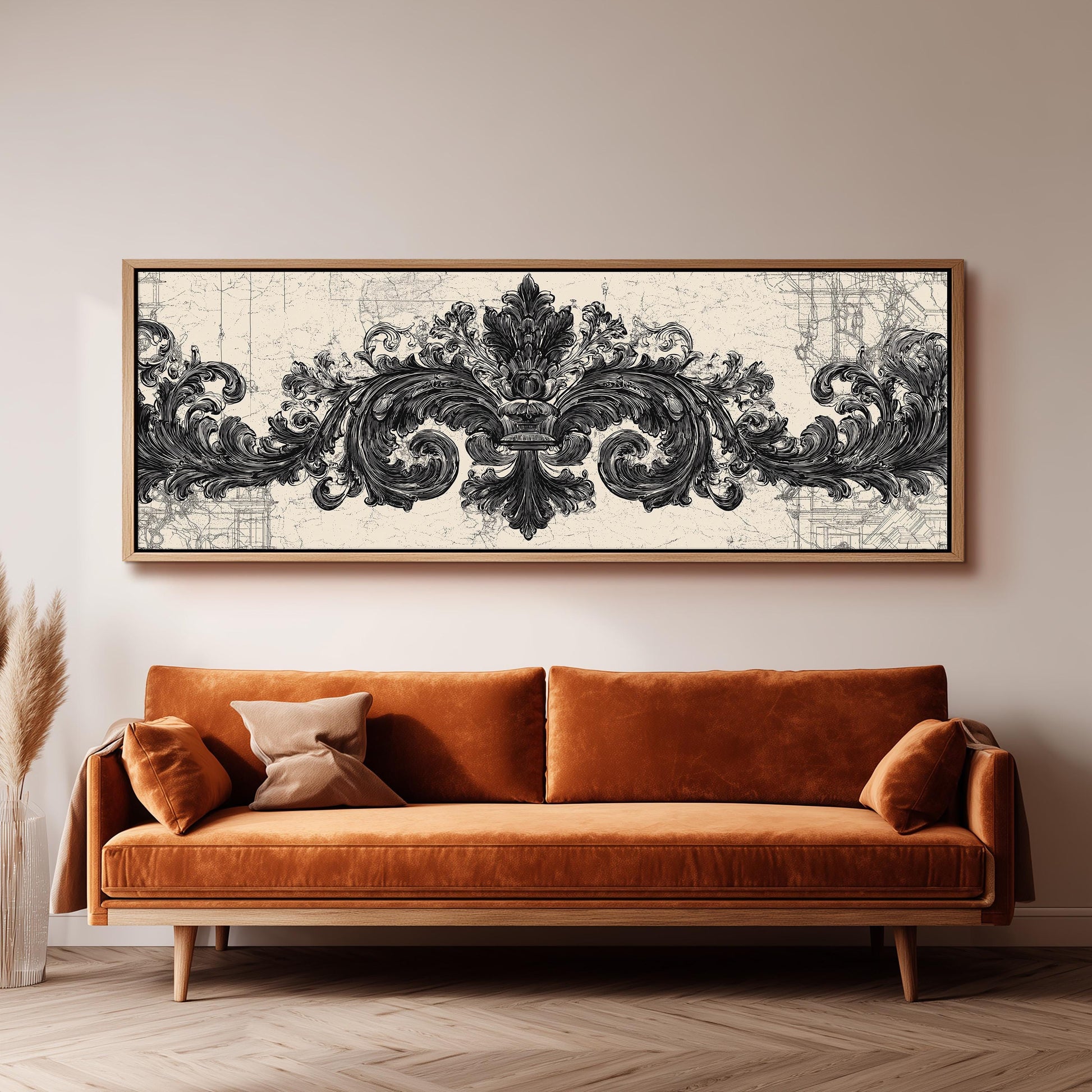 a large, ornate black and white artwork hanging on a wall above a brown sofa.