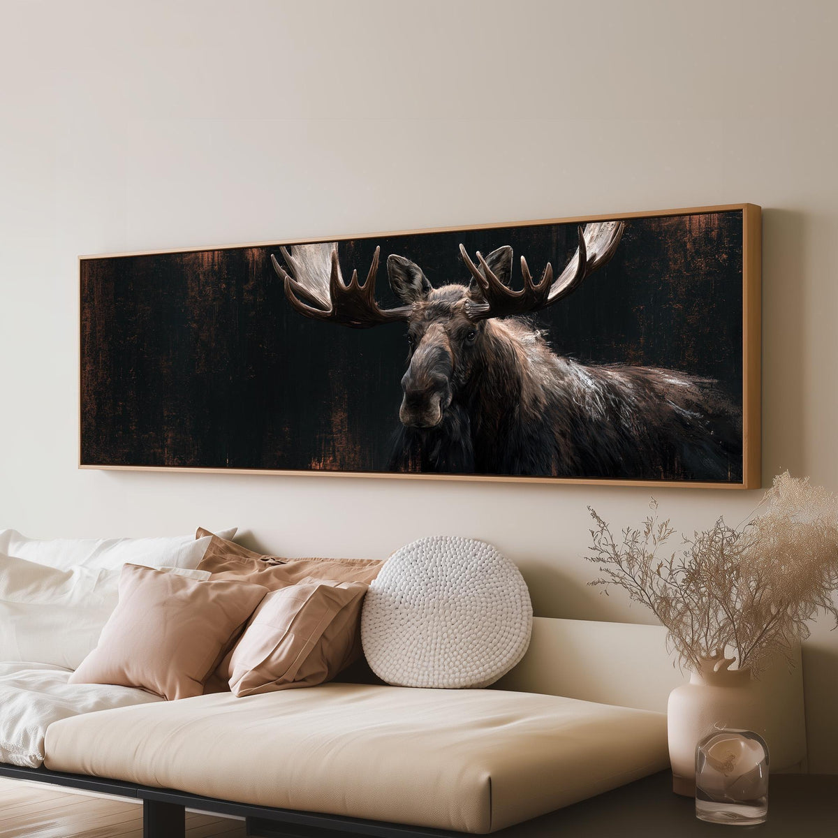 Dark moose portrait long horizontal canvas print above a sofa in a living room