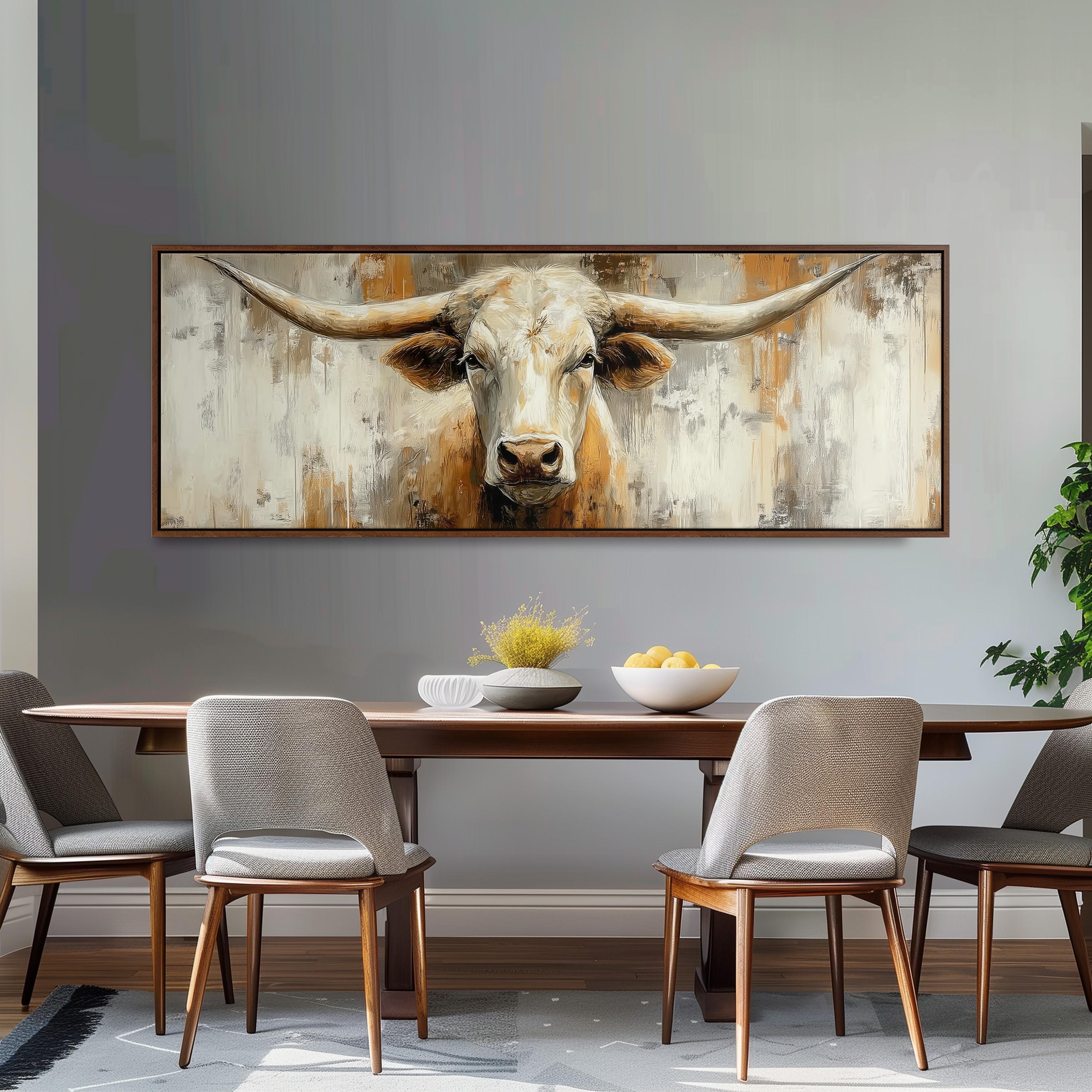 a large painting of a bull's head hanging on a wall above a wooden dining table with four chairs.