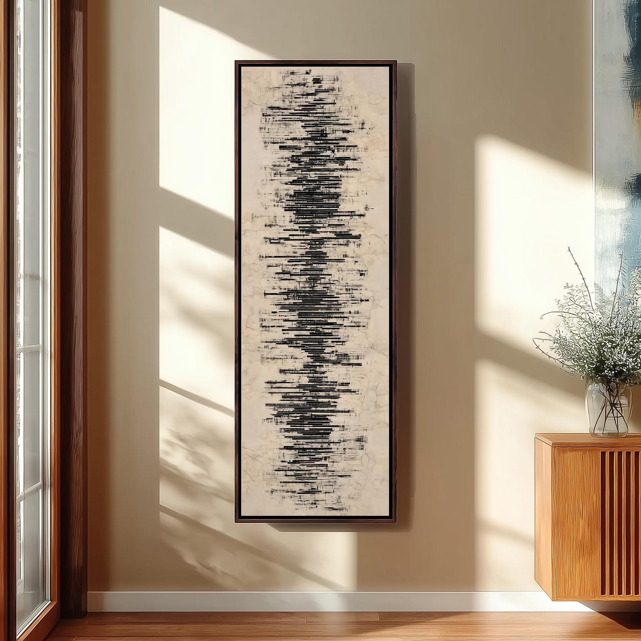 a large abstract painting hanging on a wall, with a wooden cabinet and a vase of flowers to the right of the painting.