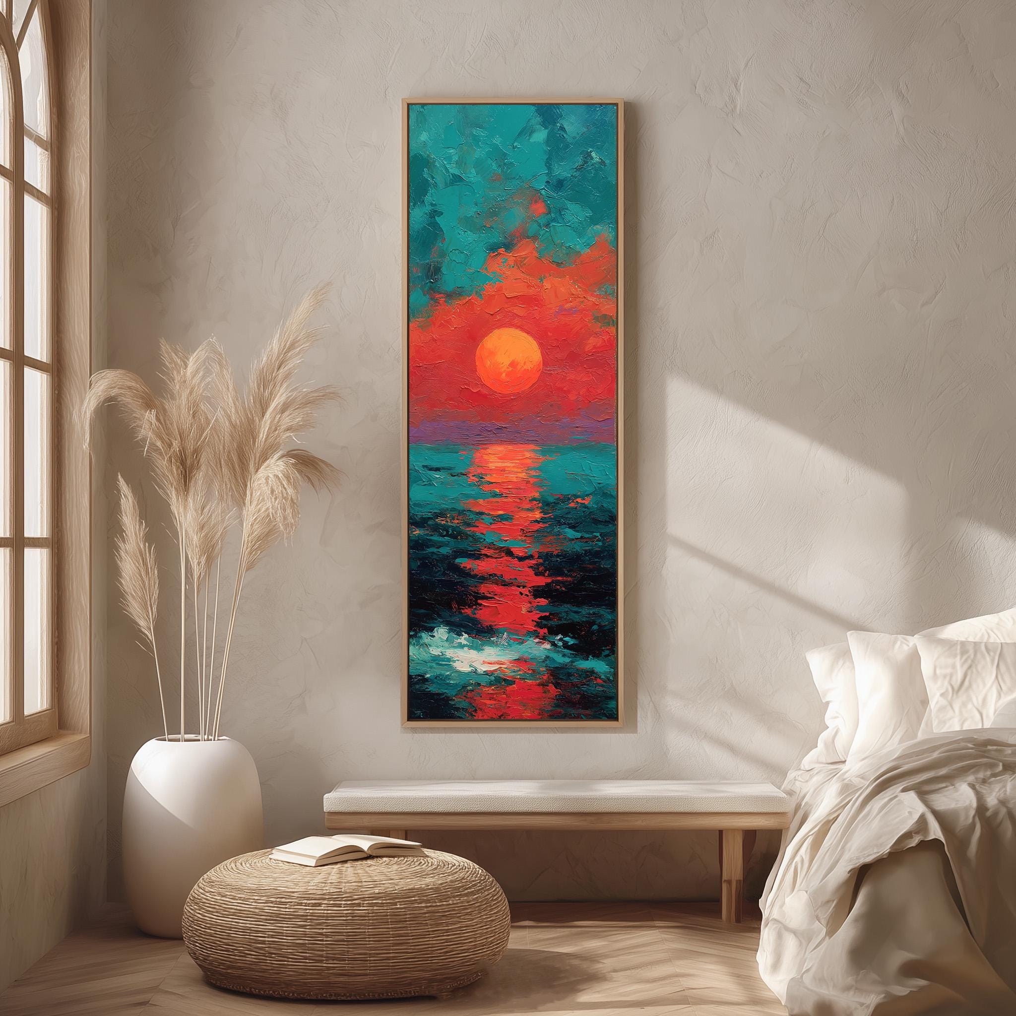 a large, colorful painting of a sunset over the ocean, hanging on a wall in a room with a bed, a potted plant, and a woven ottoman.