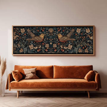a large, ornate tapestry hanging on a wall above a brown sofa with a wooden frame.