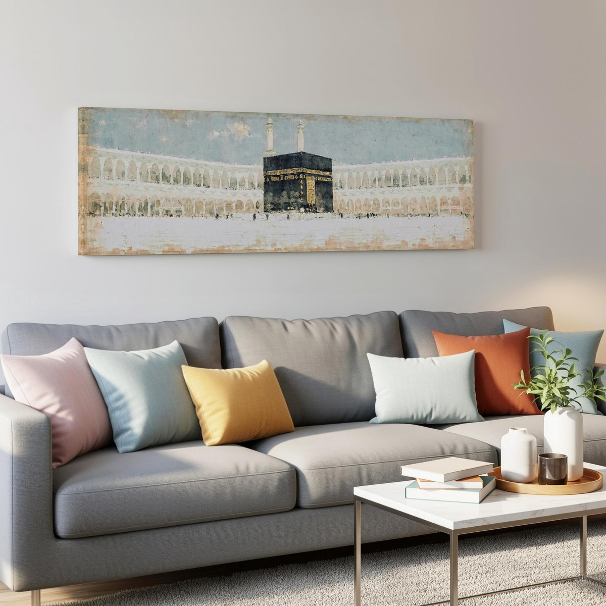 The Kaaba in the Grand Mosque courtyard panoramic canvas print above a grey sofa in a living room