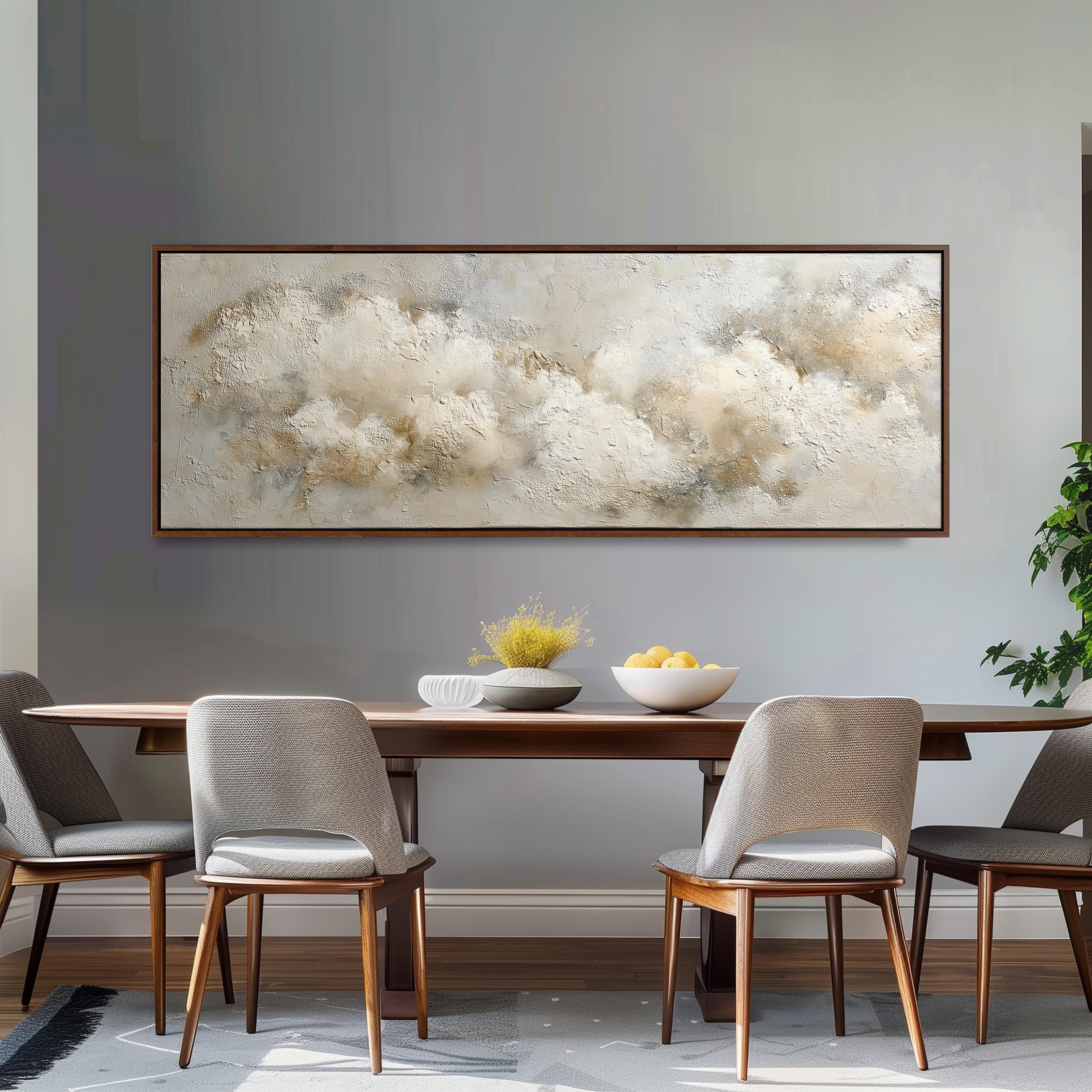 a dining room with a wooden table and four chairs, a large abstract painting hanging on the wall above the table, and a bowl of fruit on the table.