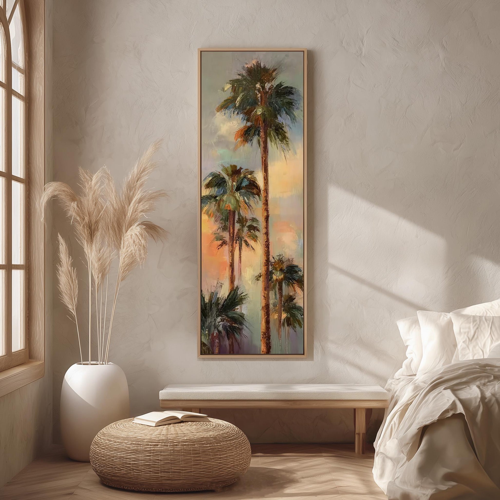 a large painting of palm trees hanging on a wall in a room with a bed, a wicker ottoman, and a potted plant.