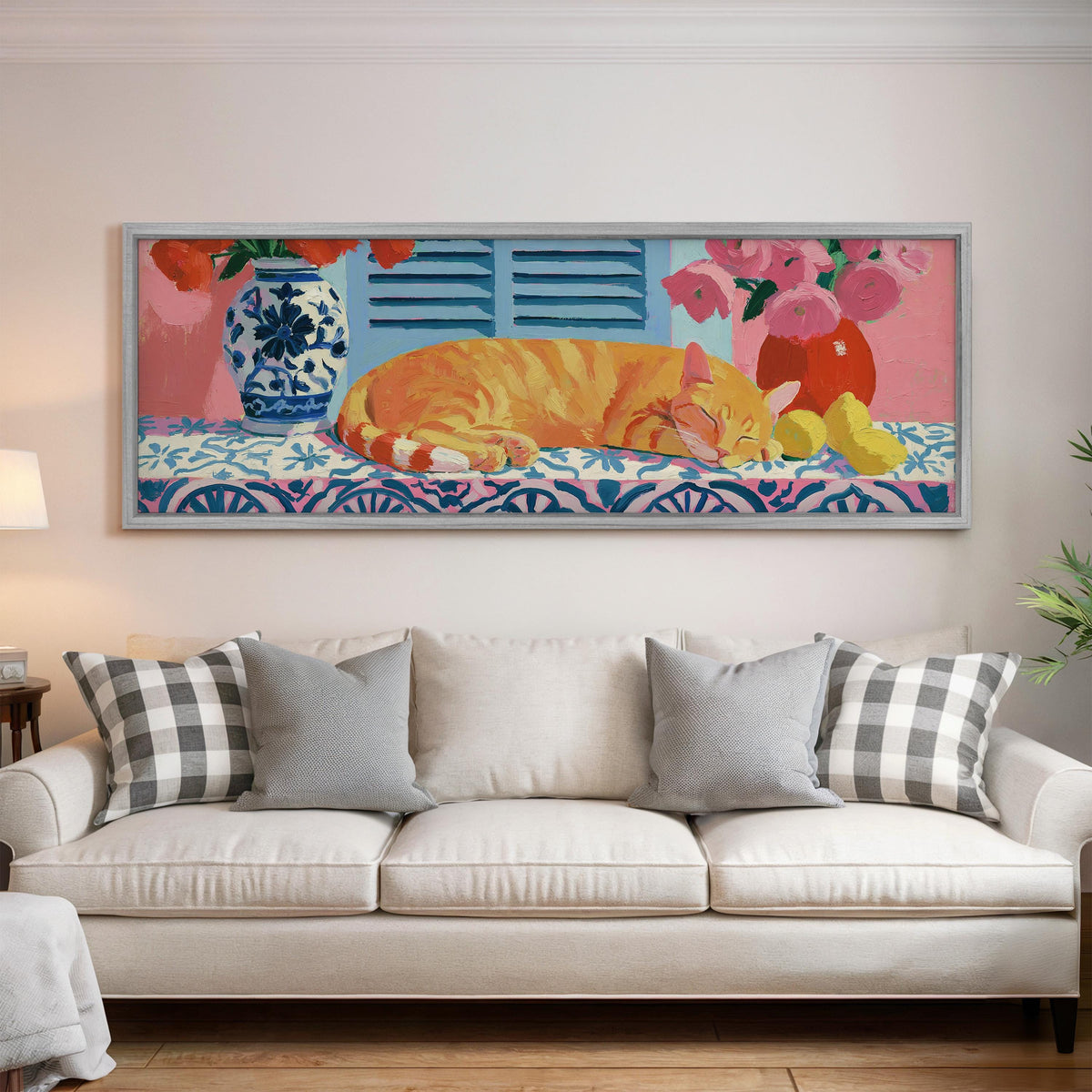 Orange cat napping on a tiled table panoramic canvas print above a white sofa in a bright living room