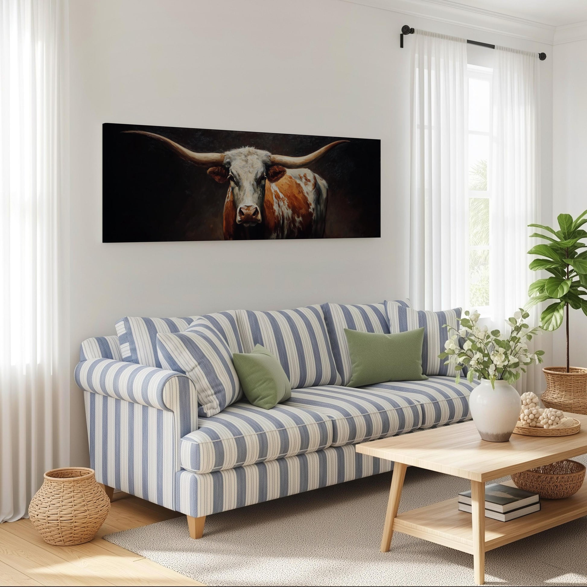 a living room with a blue and white striped sofa, a wooden coffee table, and a large painting of a bull's head on the wall.