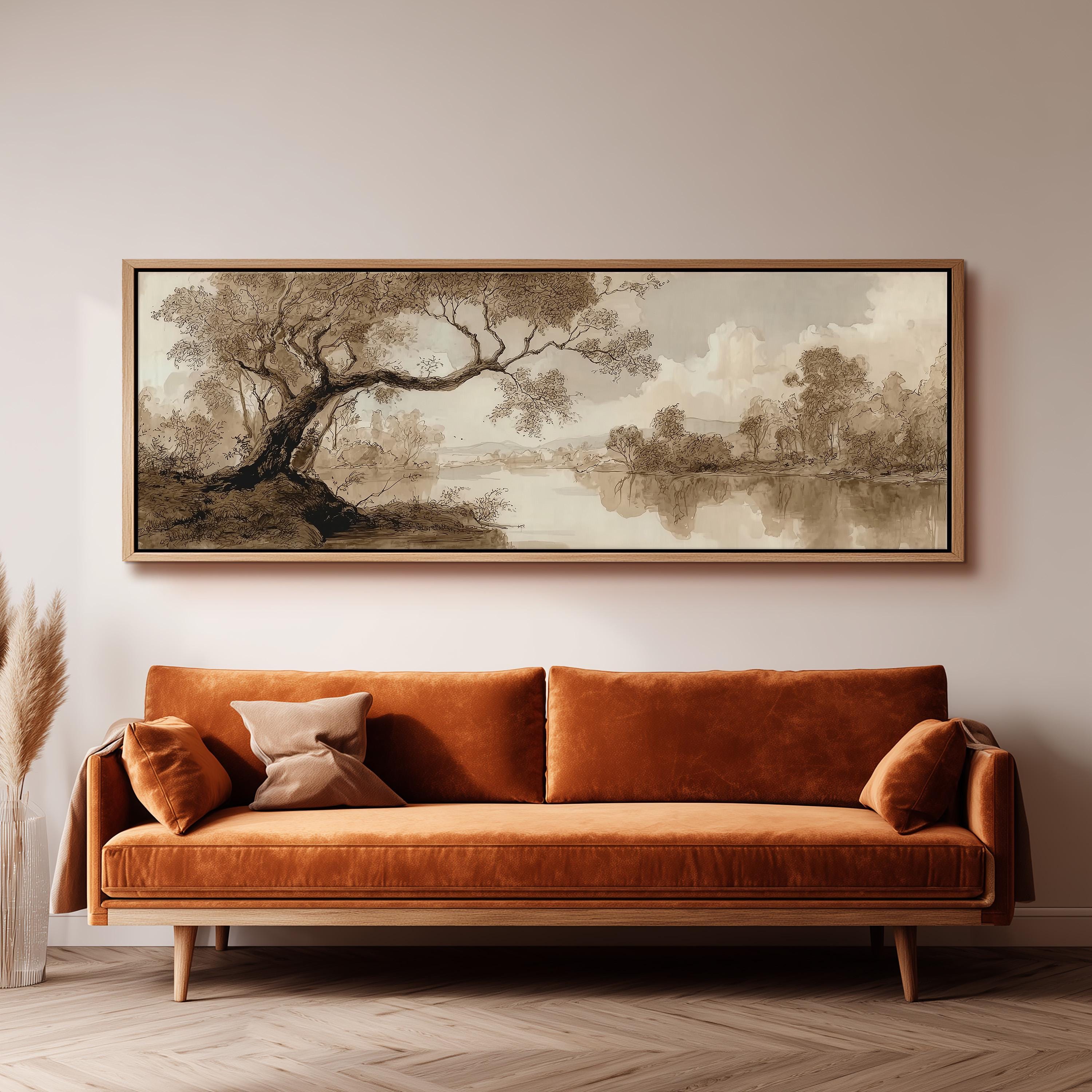 a large, framed painting of a landscape hanging on a wall above a brown sofa with orange cushions.