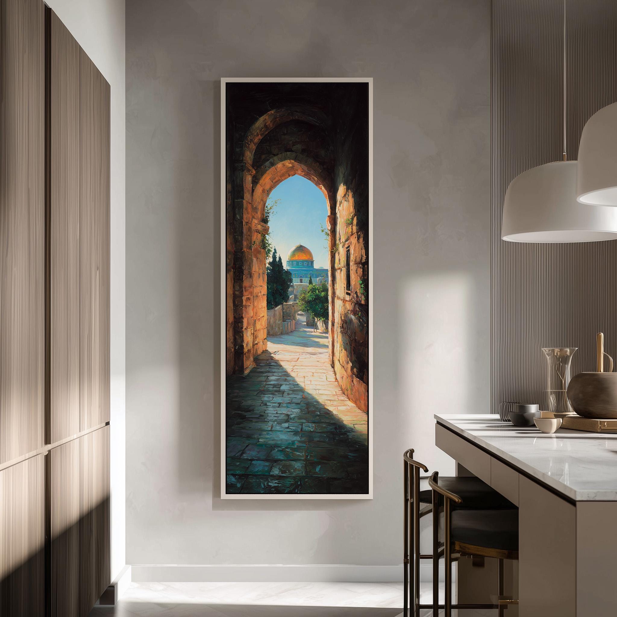 a large framed painting hanging on a wall, depicting an archway leading to a building with a dome. The painting is the central focus of the room, which includes a kitchen counter with chairs and a pendant light.