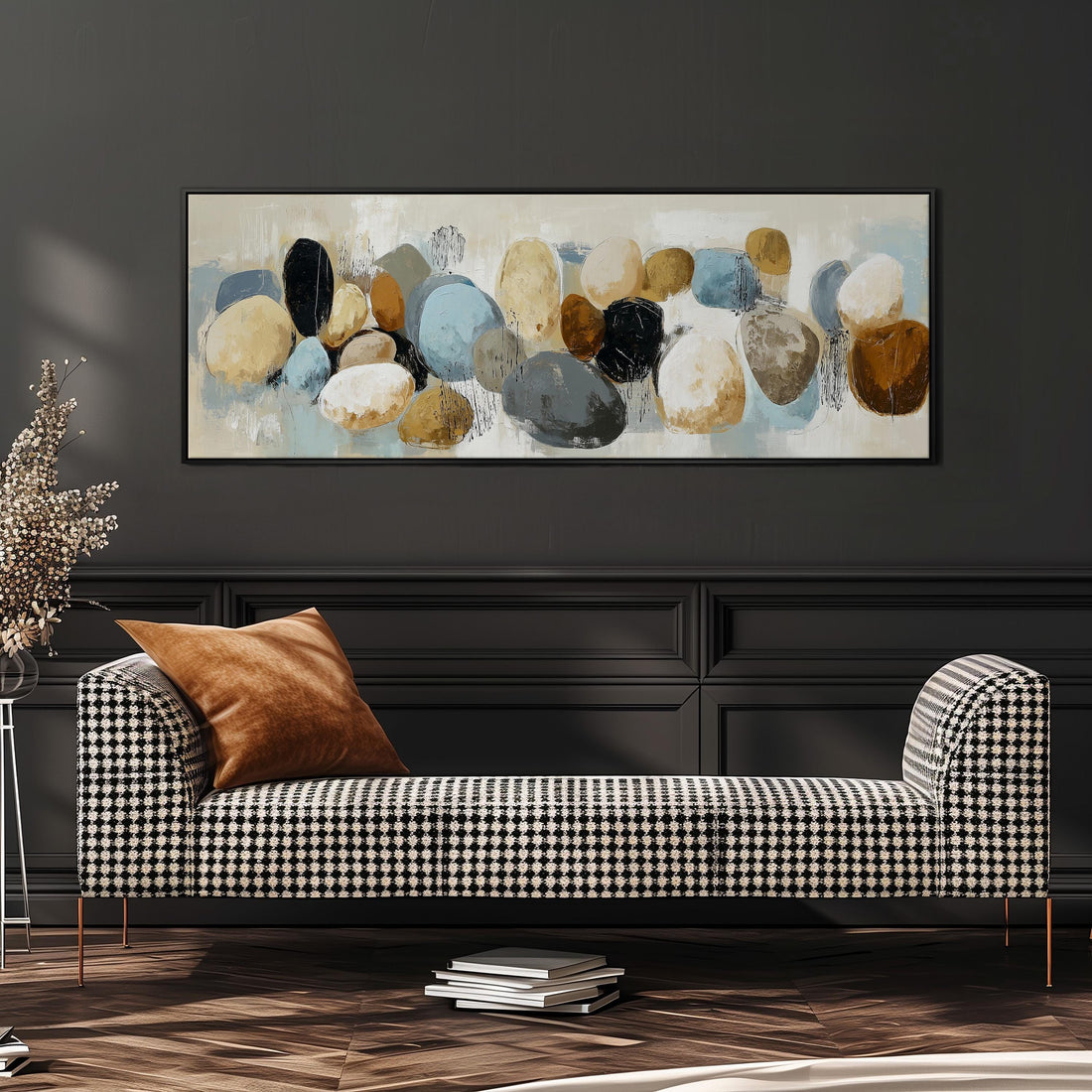 a large abstract painting hanging on a wall above a brown sofa with orange cushions.