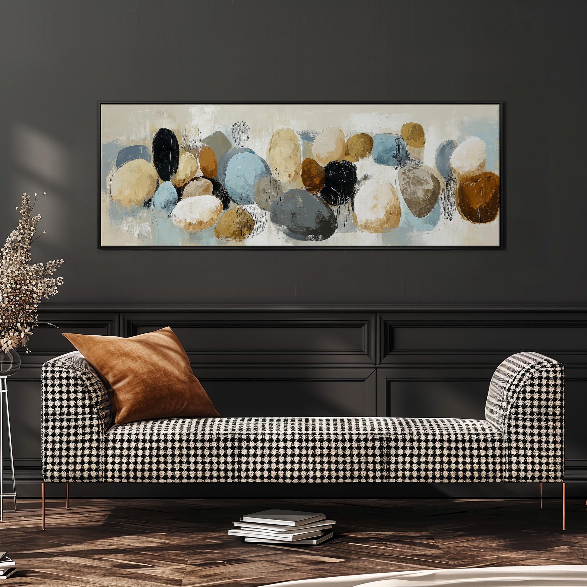 a modern living room with a black and white checkered sofa, a large abstract painting on the wall, and a stack of books on the floor.