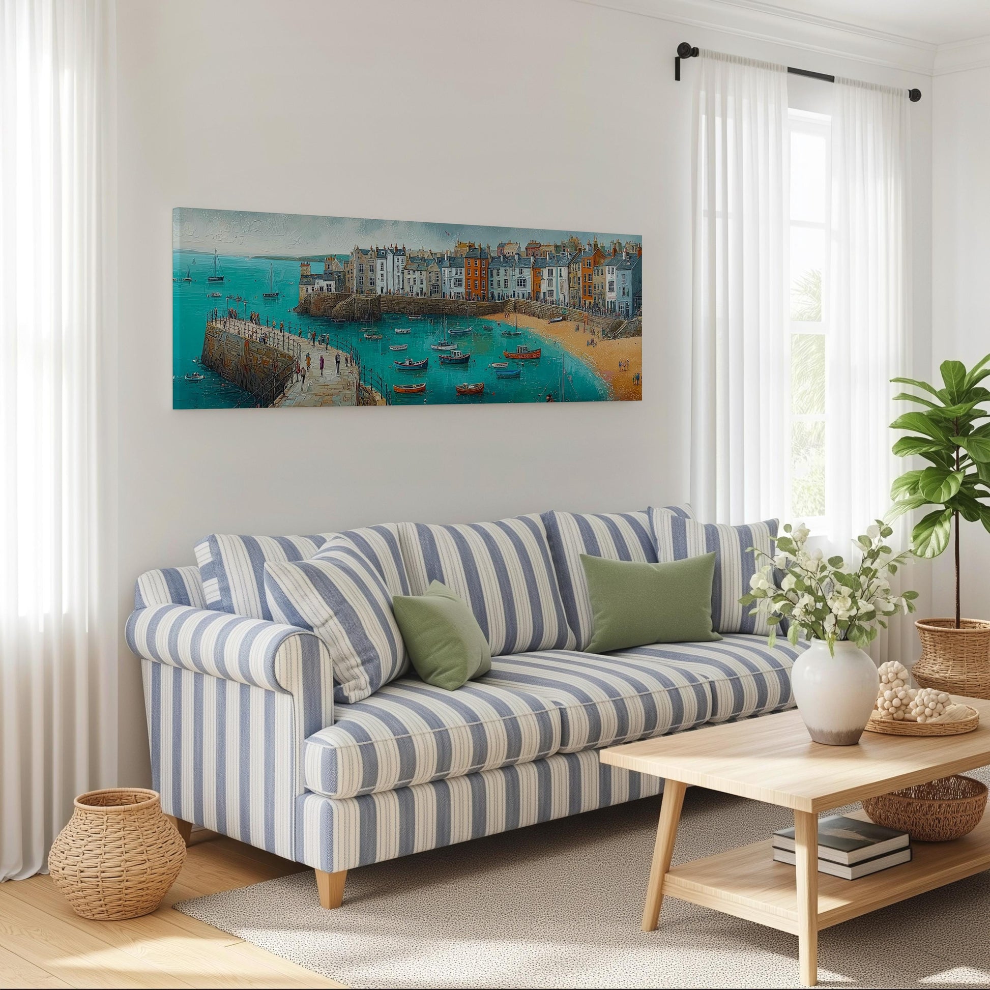 a living room with a striped blue and white sofa, a wooden coffee table, and a large painting of a coastal town on the wall.