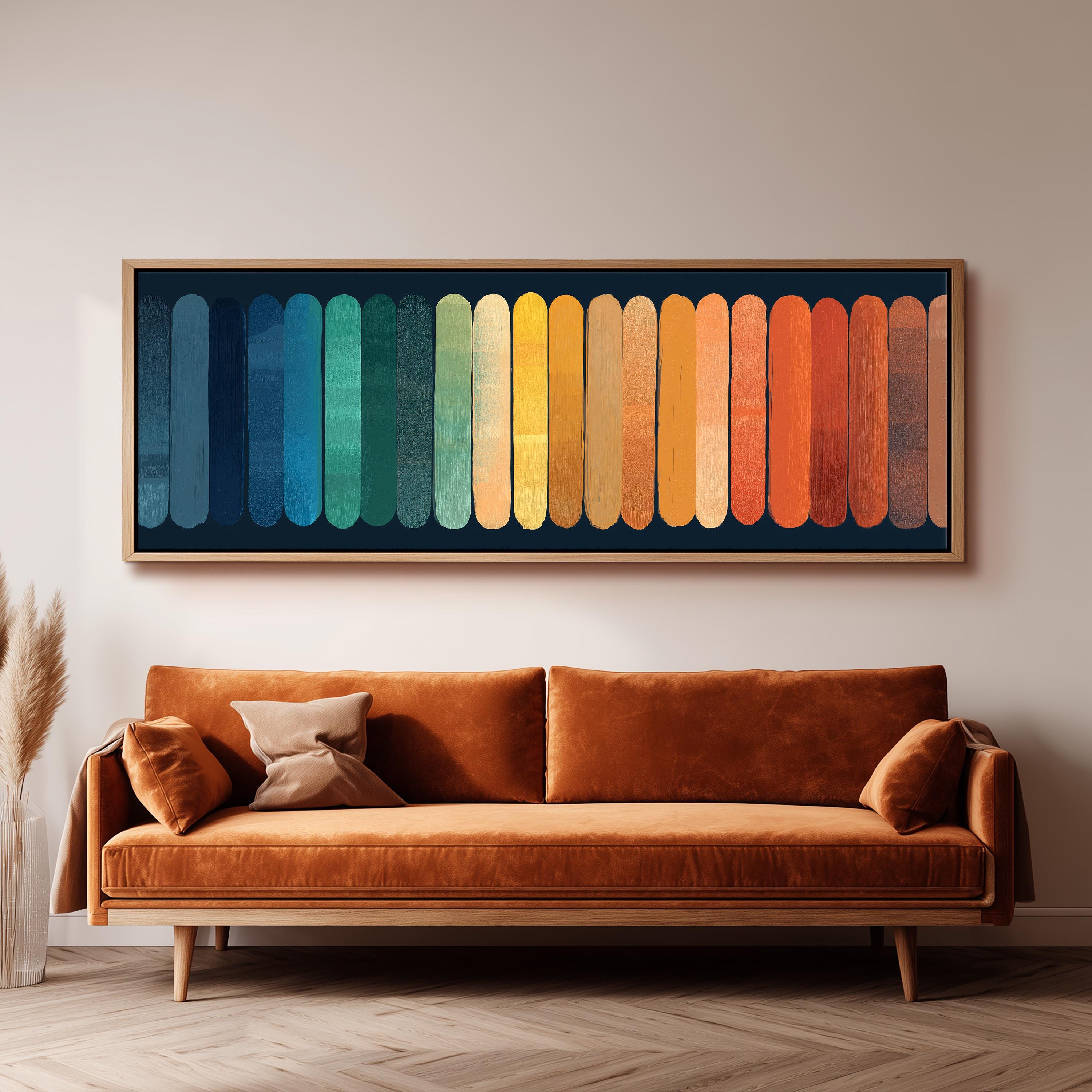 a large, vibrant painting of a rainbow-colored stripe on a wall above a brown sofa with two pillows.