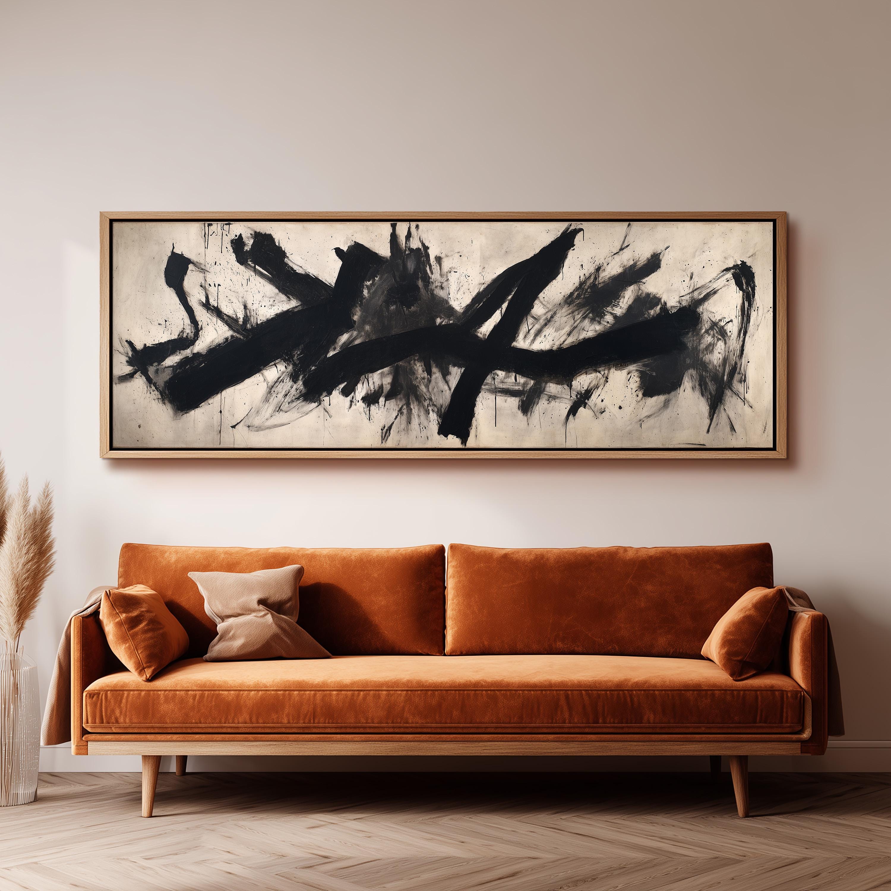 a large abstract painting hanging on a wall above a brown sofa with orange cushions.