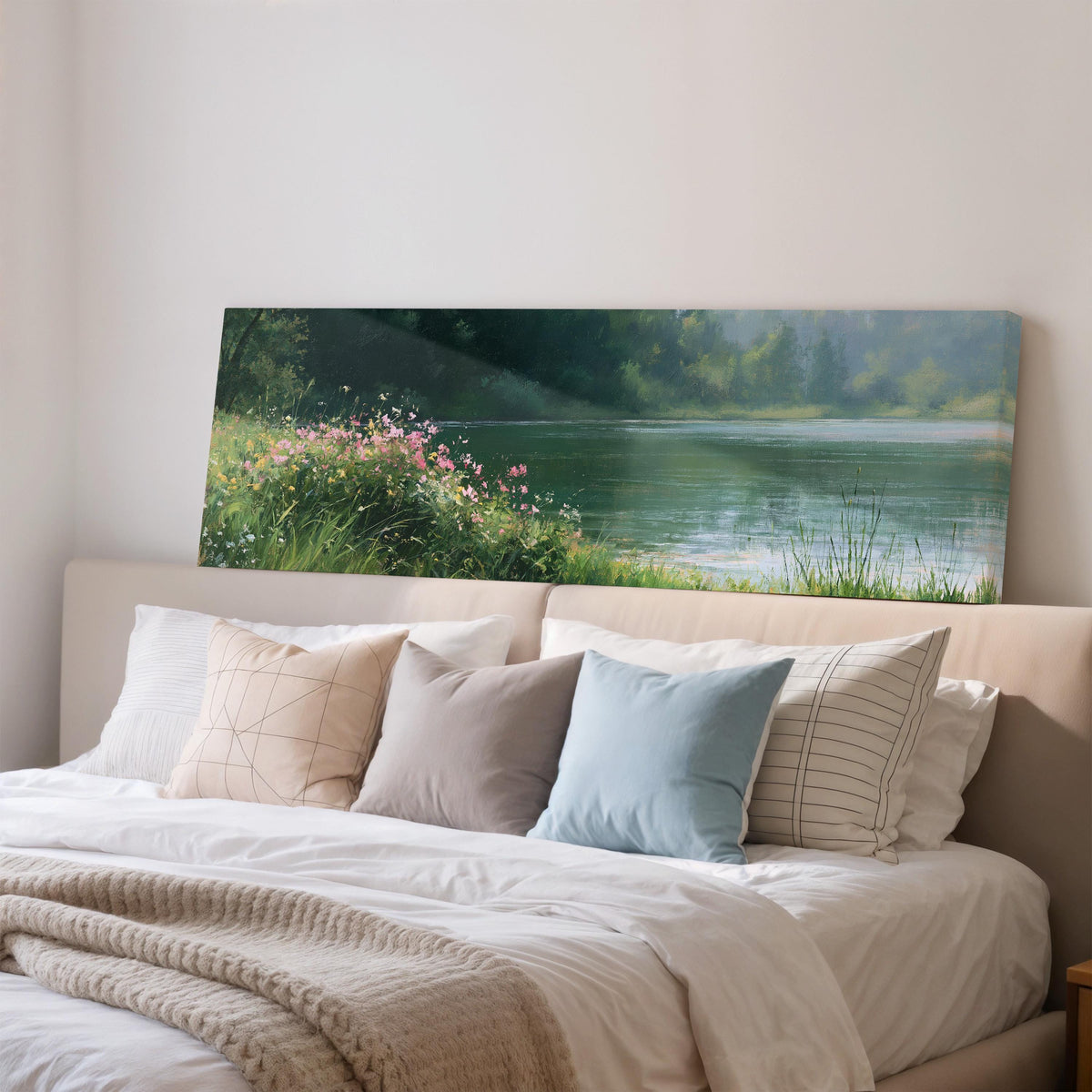 Pink wildflowers on a green lakeshore wide panoramic canvas print above a bed in a bedroom