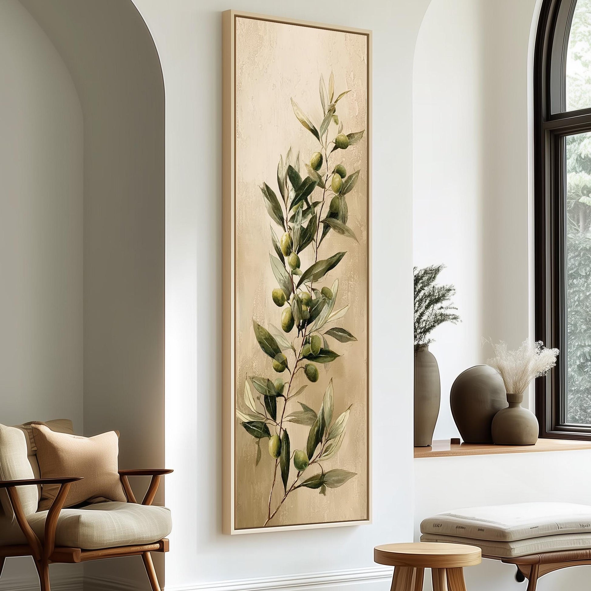 a living room with a large painting of green leaves and branches hanging on the wall, a wooden chair, a small table, and a window with a plant on the sill.