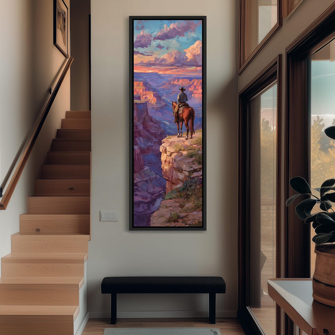 a large framed painting of a cowboy on a horse overlooking a scenic landscape, with a dramatic sky and clouds in the background.