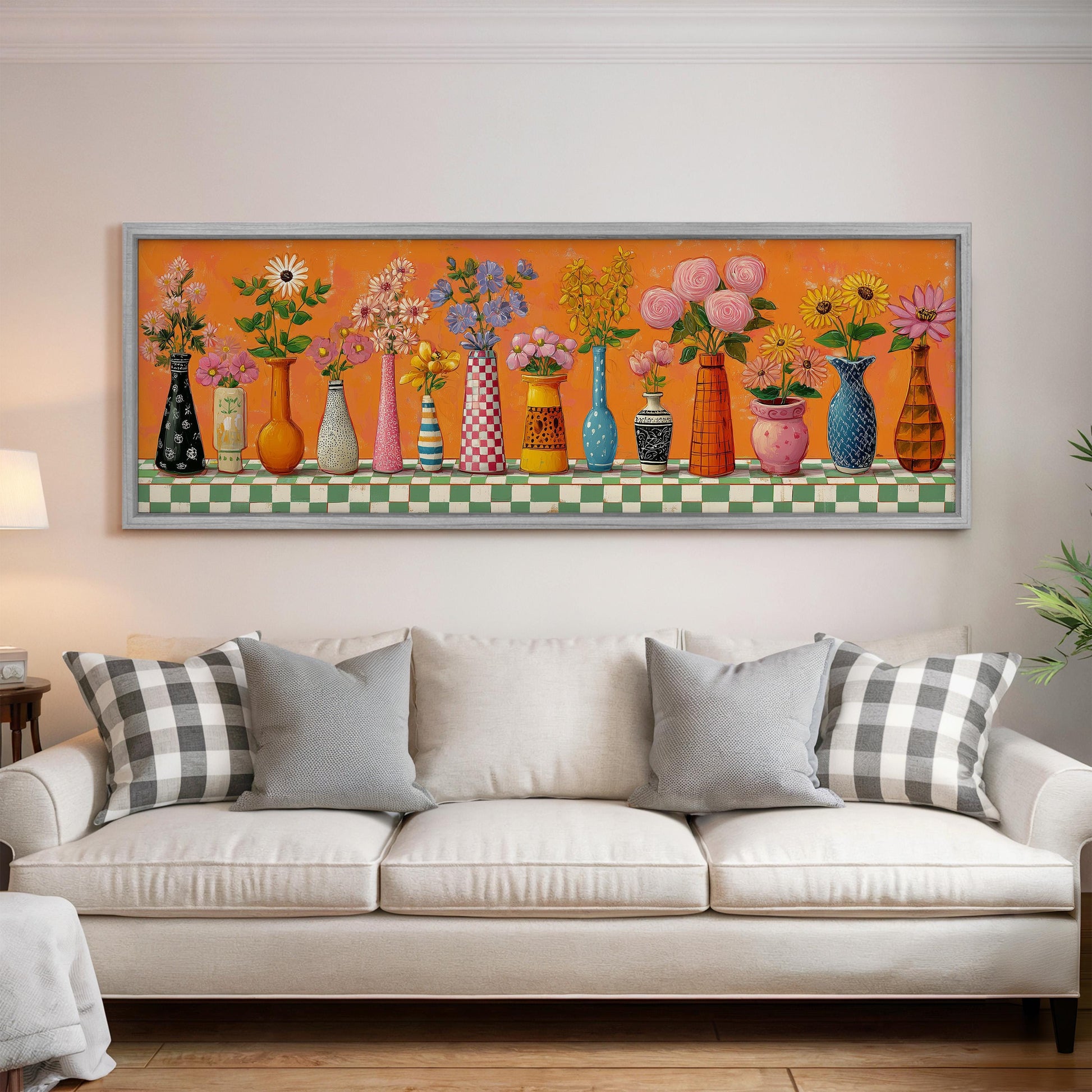 a large, colorful painting of various vases and flowers displayed on a wall above a white couch in a living room setting.