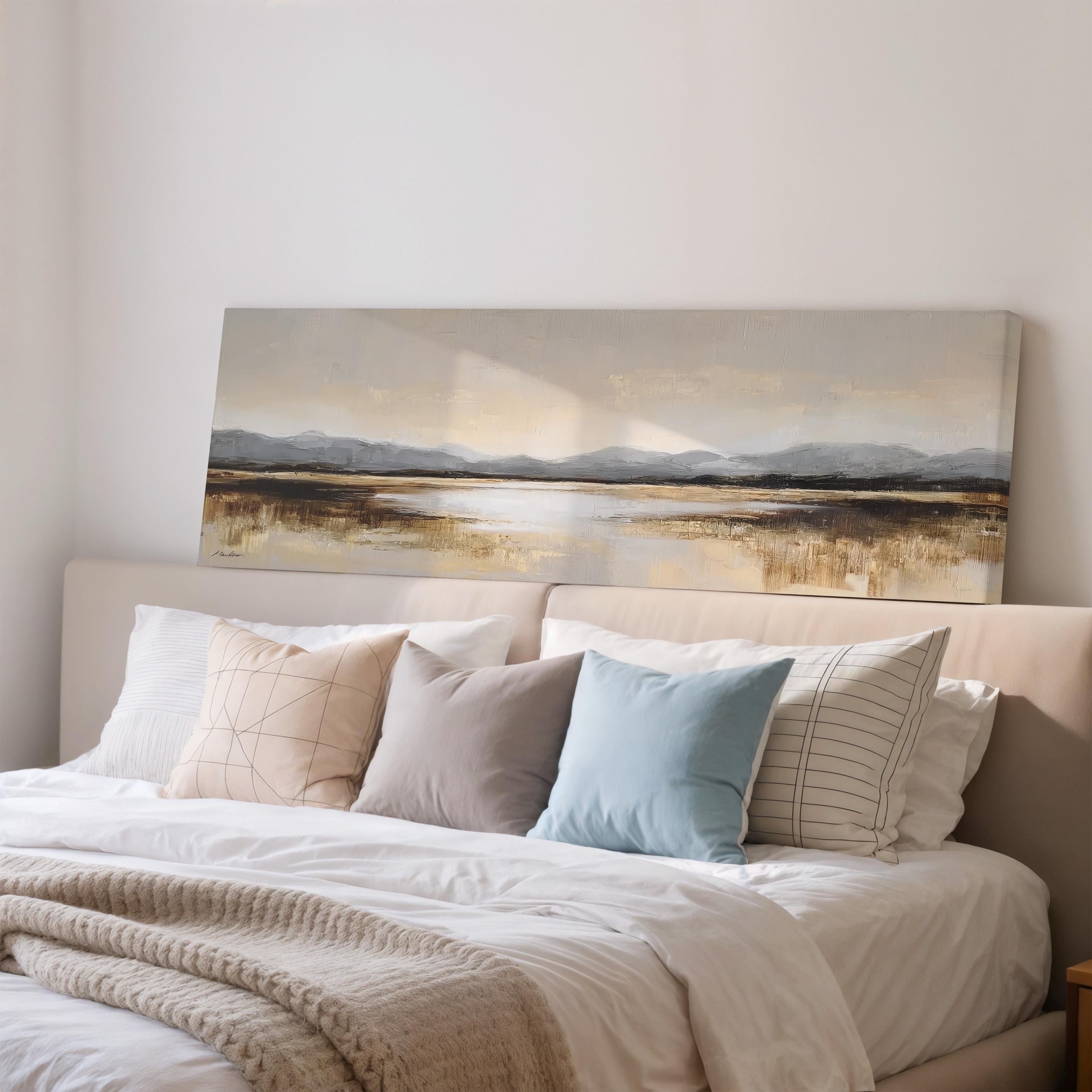a large painting of a landscape hanging above a bed with white bedding and various pillows.