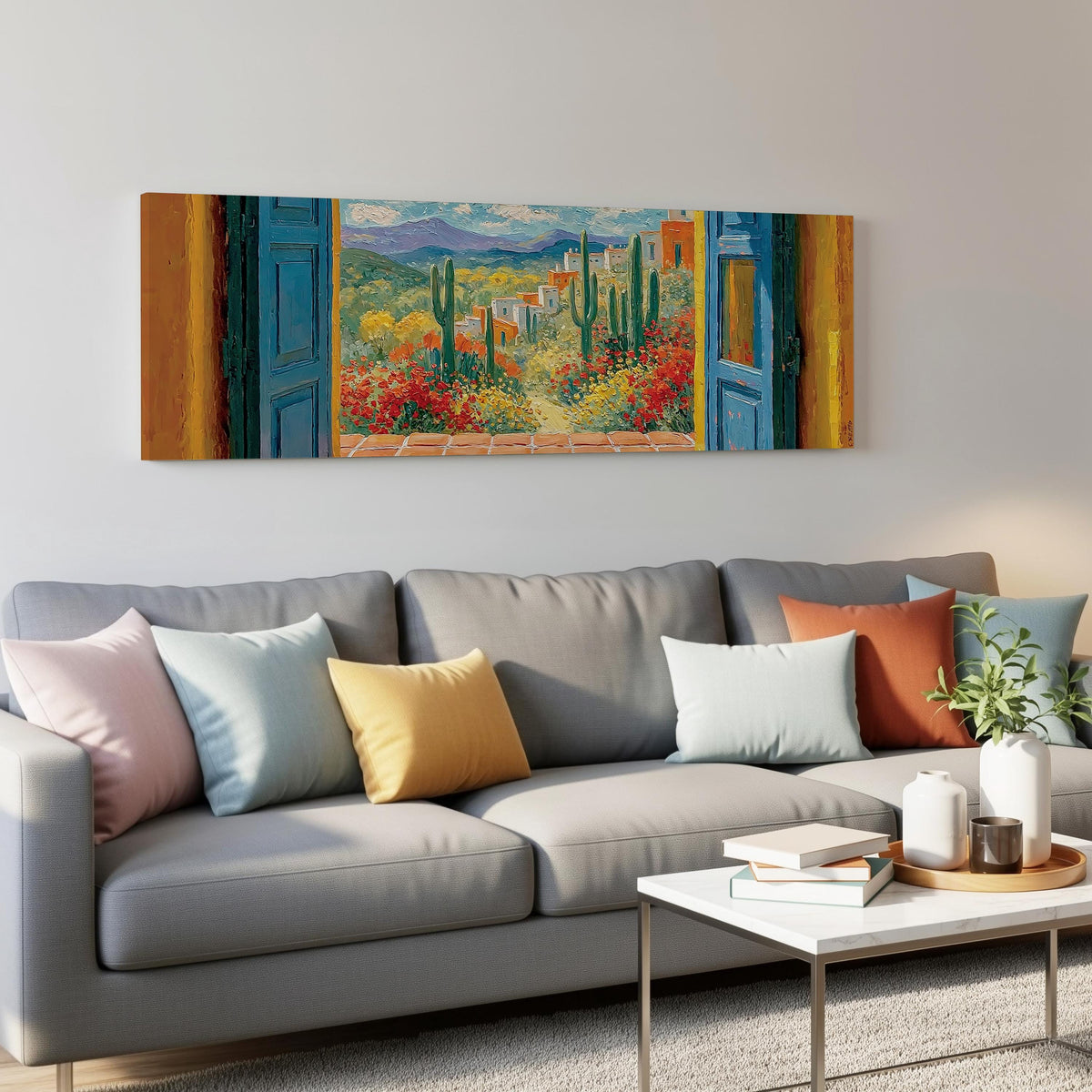 Cactus courtyard seen through blue doors panoramic canvas print above a grey sofa in a living room
